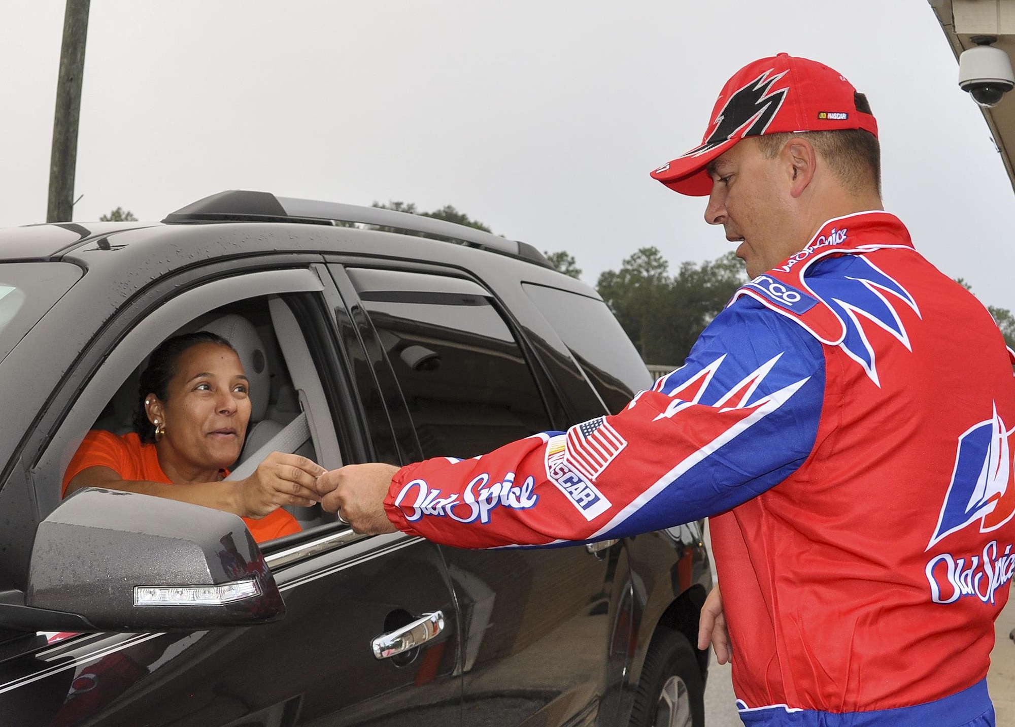 Chief Master Sgt. Brian Bischoff, 919th Special Operations Wing command chief, dresses as “Cal Naughton Jr.” from “Talladega Nights” to greet wing members at the gate at the beginning of the unit training assembly Nov. 6 at Duke Field.  The wing’s vice commander joined the chief dressed as “Ricky Bobby.”  (U.S. Air Force photo/Dan Neely)