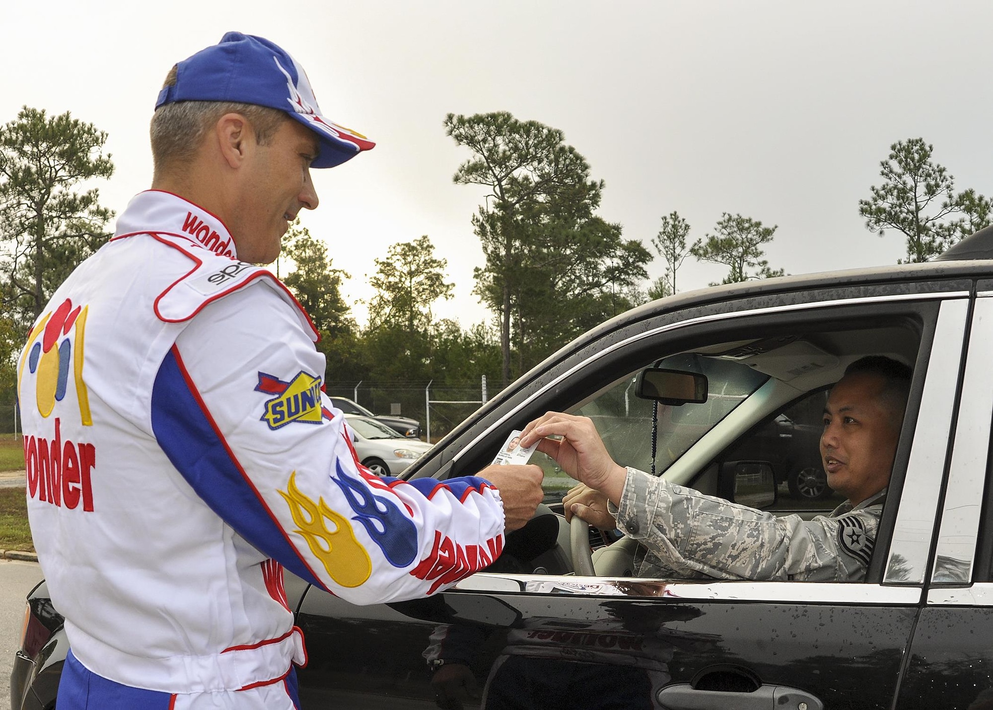 Col.  Robert Bruckner, 919th Special Operations Wing vice commander, dresses as “Ricky Bobby” from “Talladega Nights” to greet wing members at the gate at the beginning of the unit training assembly Nov. 6 at Duke Field.  The wing’s command chief joined the vice dressed as “Cal Naughton Jr.”  (U.S. Air Force photo/Dan Neely)