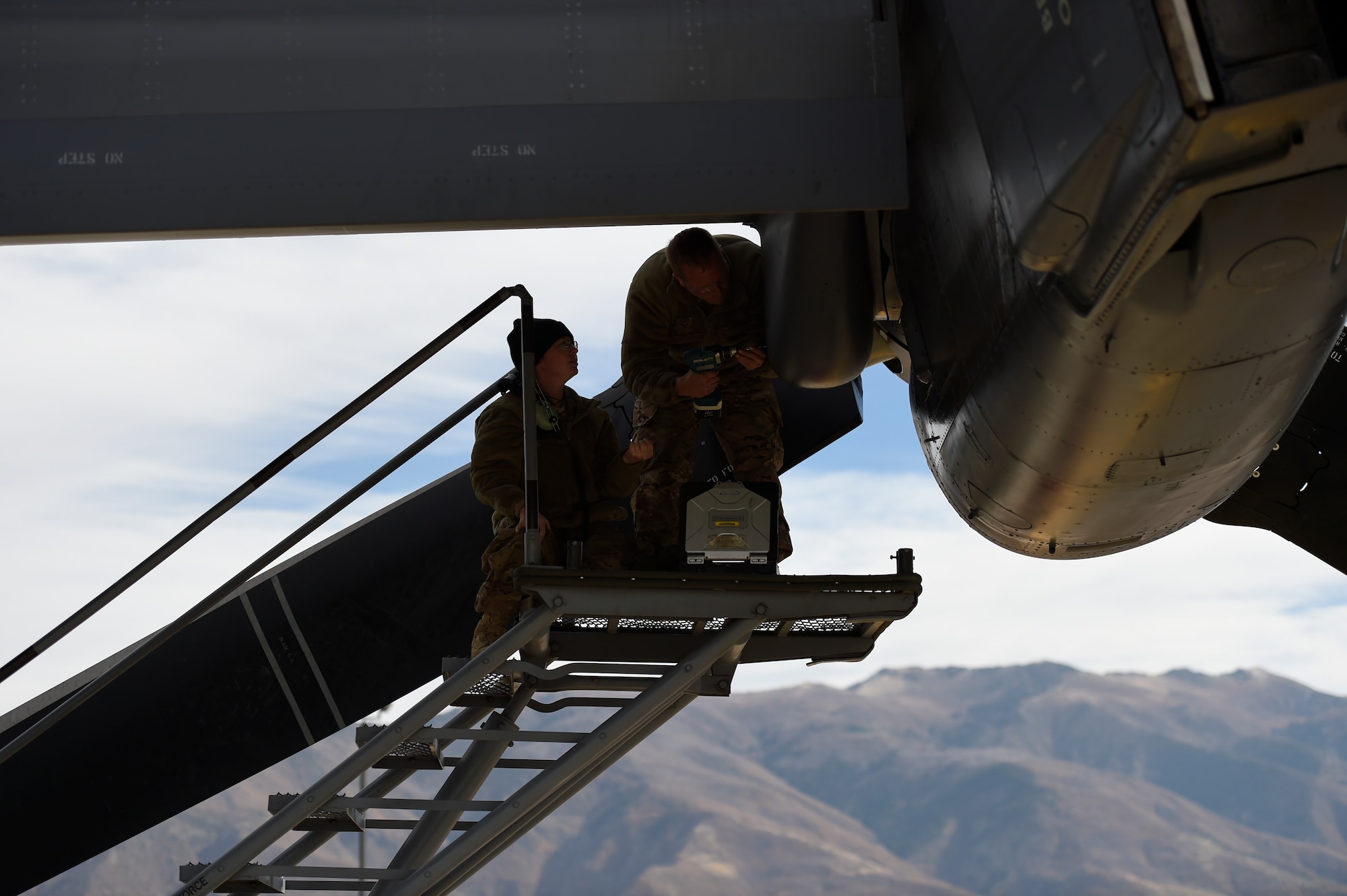 Staff Sgt. Melissa Moss and Senior Airman Daniel Gurka, crew chiefs with the 901st Aircraft Maintenance Squadron, reattach an engine cover after performing maintenance on a CV-22B Osprey at Hill Air Force Base, Utah, Nov. 2, 2015. The exercise allowed Airmen to perform their duties in a simulated expeditionary environment outside of their home stations. (U.S. Air Force by Airman Kai White)
