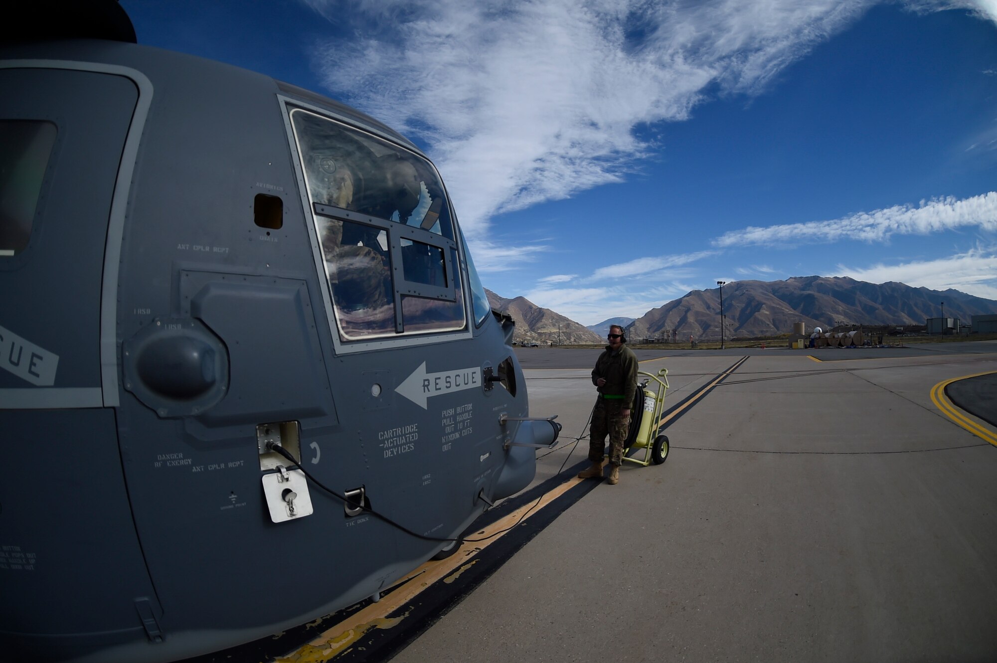 Senior Airman Daniel Gurka, a crew chief with the 901st Aircraft Maintenance Squadron, performs preflight checks on a CV-22B Osprey before an orientation flight at Hill Air Force Base, Utah, Nov. 2, 2015. The exercise allowed Airmen to perform their duties in a simulated expeditionary environment outside of their home stations. (U.S. Air Force by Airman Kai White)