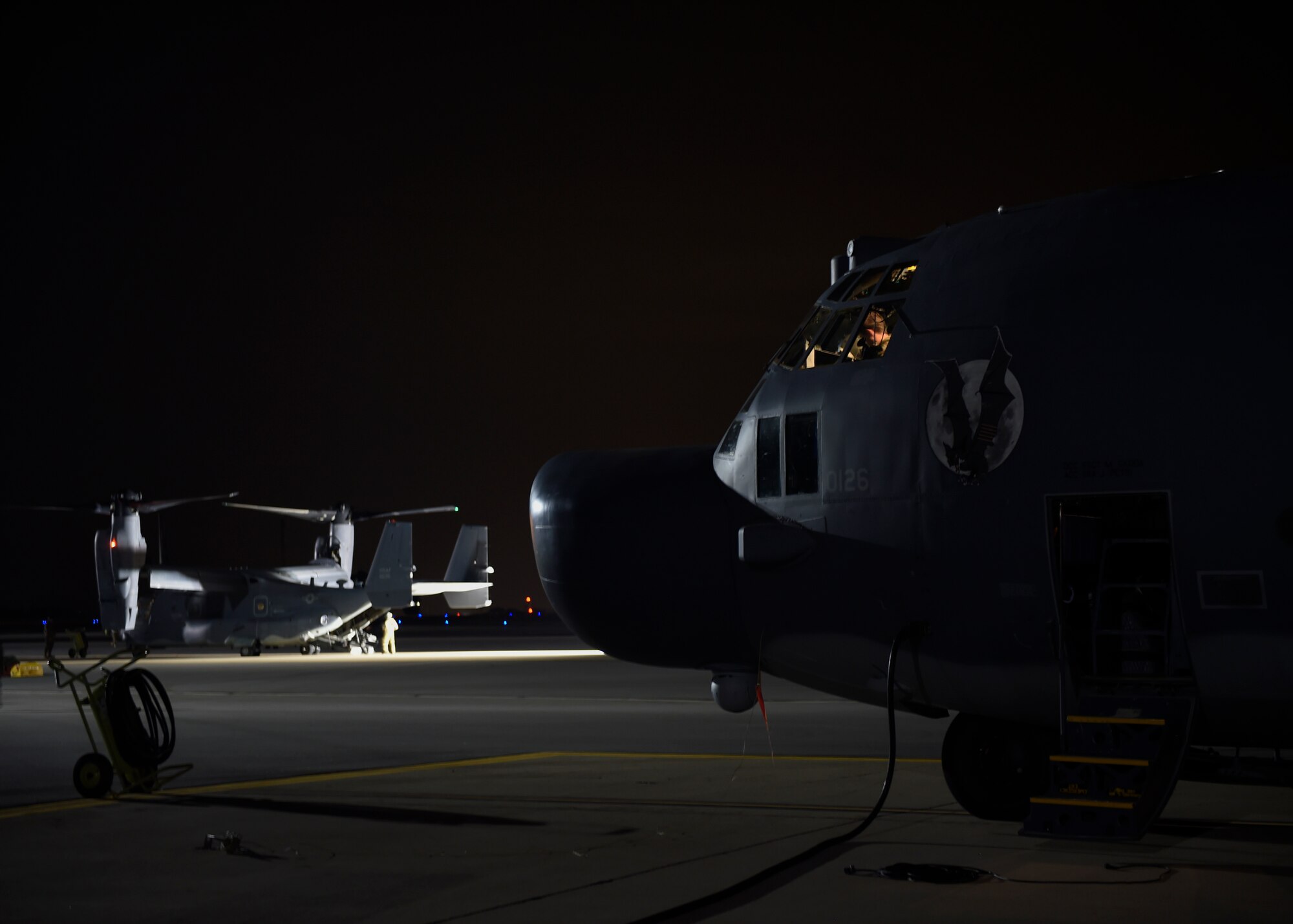 Airmen prepare an MC-130 Combat Talon II and a CV-22B Osprey for a low-level night flight at Hill Air Force Base, Utah, Nov. 2, 2015. The exercise allowed Airmen to perform their duties in a simulated expeditionary environment outside of their home stations. (U.S. Air Force by Airman Kai White)