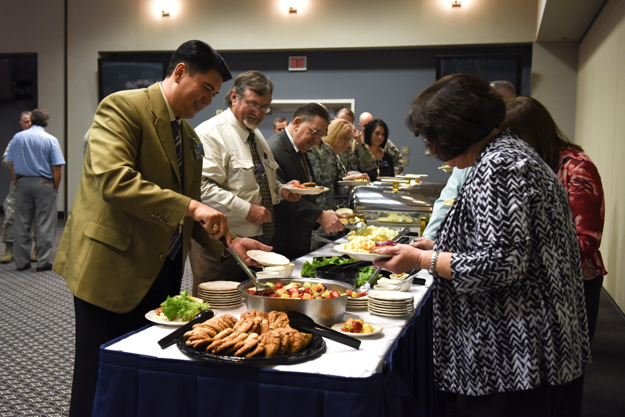 Participants at the Honorary Commanders Luncheon get food at the Event Center on Goodfellow Air Force Base, Texas, Nov. 5, 2015. After eating, U.S. Air Force Col. Michael L. Downs, 17th Training Wing Commander, gave a presentation about the wing mission. (U.S. Air Force photo by Airman Chase Sousa/Released)