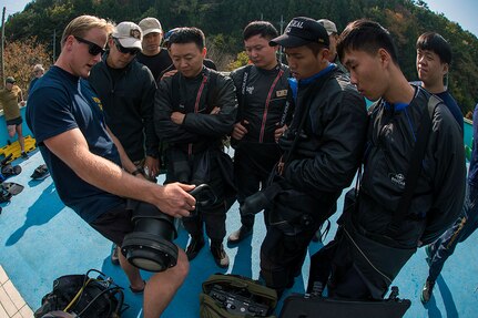 Explosive Ordnance Disposal (EOD) technician 3rd Class Aaron Ainley, left, assigned to EOD Mobile Unit (EODMU) 1, explains the functions of the DNS-300 underwater sonar system to Republic of Korea Navy UDT/SEALs during Exercise Clear Horizon 2015 on Commander Fleet Activities Chinhae.  Exercise Clear Horizon is an annual bilateral exercise between the U.S. and Republic of Korea navies that focus on increasing capabilities and coordination between ships, and aircraft in mine countermeasures in international waters surrounding the Korean peninsula.  