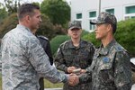 Republic of Korea Air Force Brig. Gen. Junsik Kim, 1st Fighter Wing commander, greets U.S. Air Force Brig. Gen. Barry Cornish, 18th Wing commander, during his visit.  Vigilant Ace is part of a continuous exercise program designed to enhance readiness of U.S. and ROK forces. 