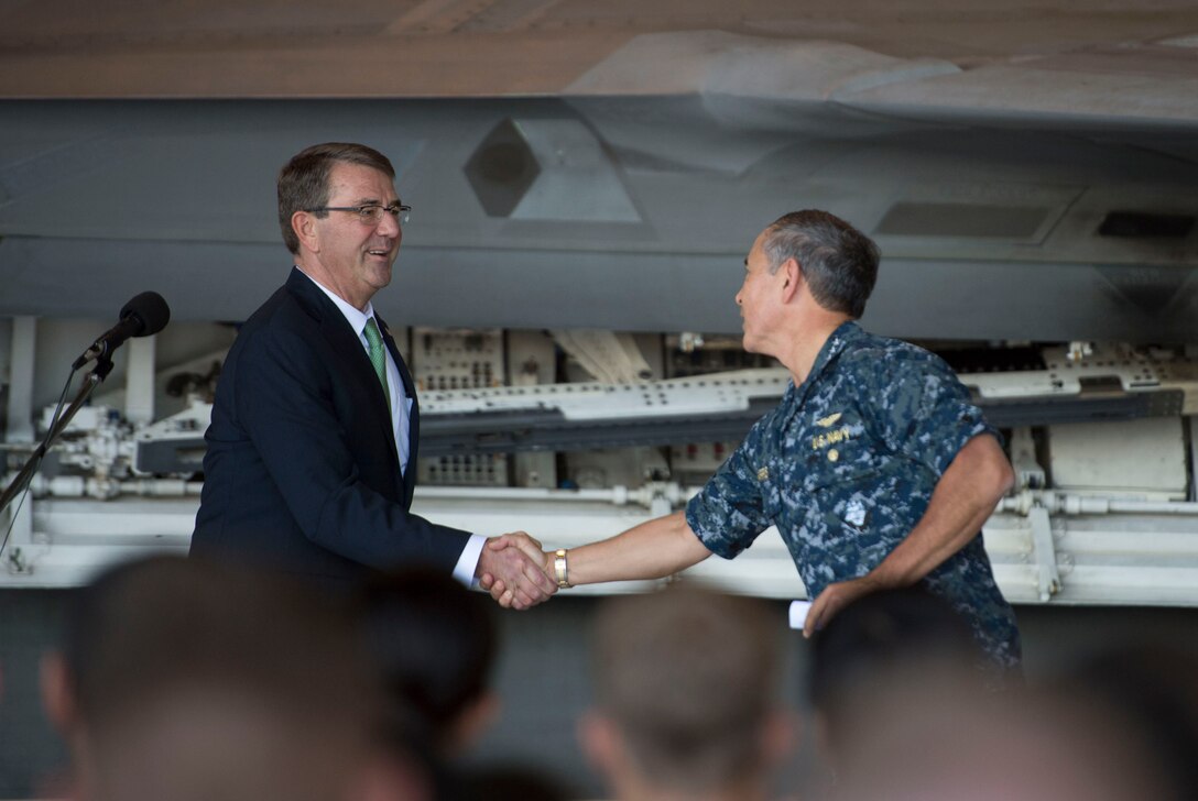 Defense Secretary Ash Carter shakes hands with Navy Adm. Harry B. Harry Jr., commander of U.S. Pacific Command, before speaking with service members on Joint Base Pearl Harbor-Hickam in Honolulu, Nov. 6, 2015. DoD photo by Air Force Senior Master Sgt. Adrian Cadiz
