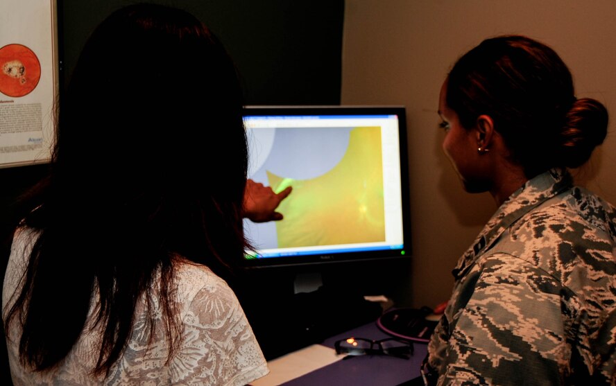 Capt. Shirley De La Rosa, 2nd Aerospace Medical Squadron Optometrist, analyzes a patient's retina at Barksdale Air Force Base, La., Oct. 22, 2015. During an eye exam, the optometrist took a photo of a patient's eye to look see if there were any vision or life threatening diseases. (U.S. Air Force photo/Staff Sgt. Jason McCasland) 