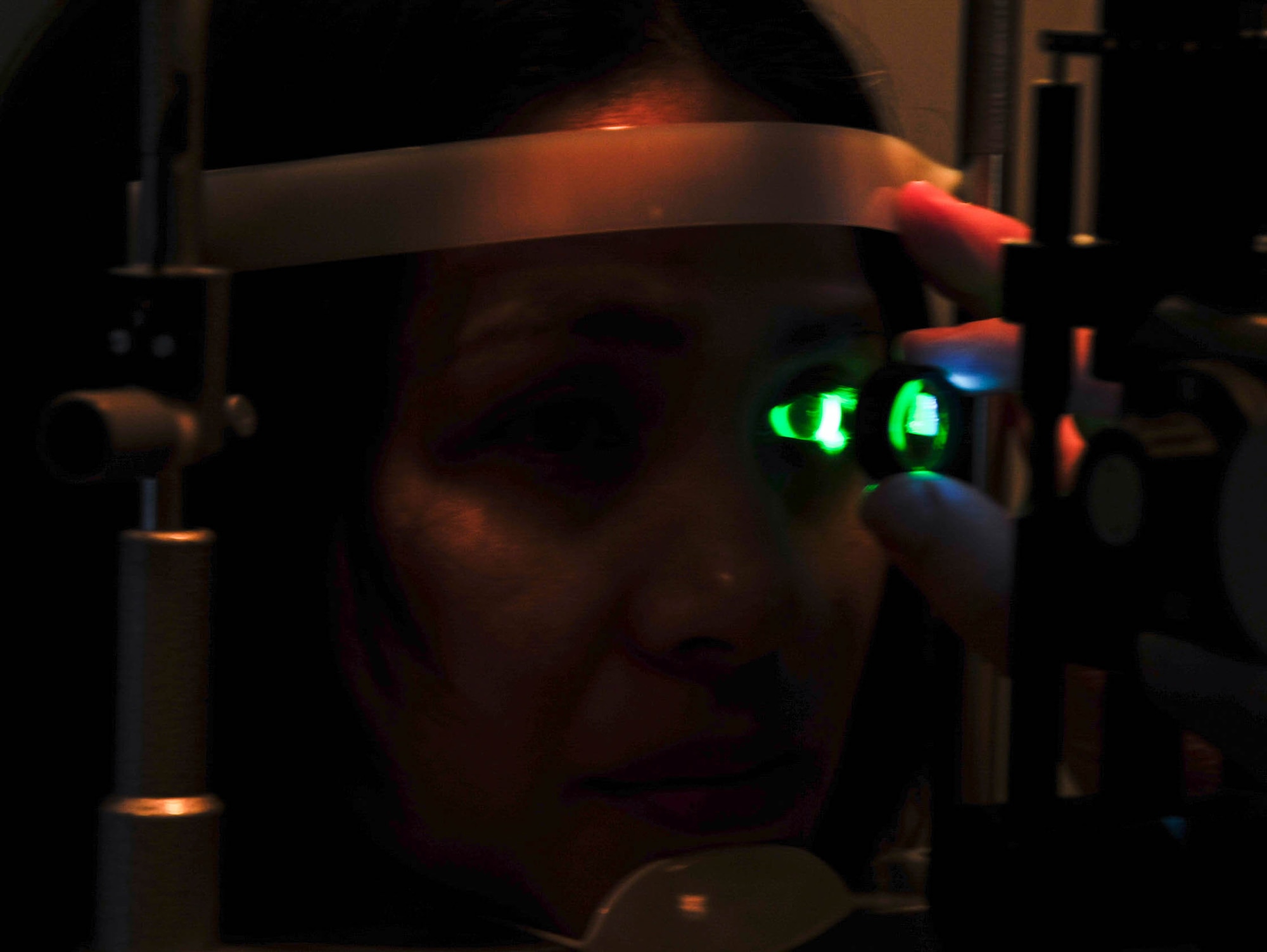 Chizu McCasland has her eye examined with a slit lens at Barksdale Air Force Base, La., Oct. 22, 2015. The slit lamp was used to get a close look at the cornea. A standard eye exam will consist of a visual acuity check to determine a change in vision and other procedures to ensure the patient's eyes are healthy and free of disease. (U.S. Air Force photo/Staff Sergeant Jason McCasland)
