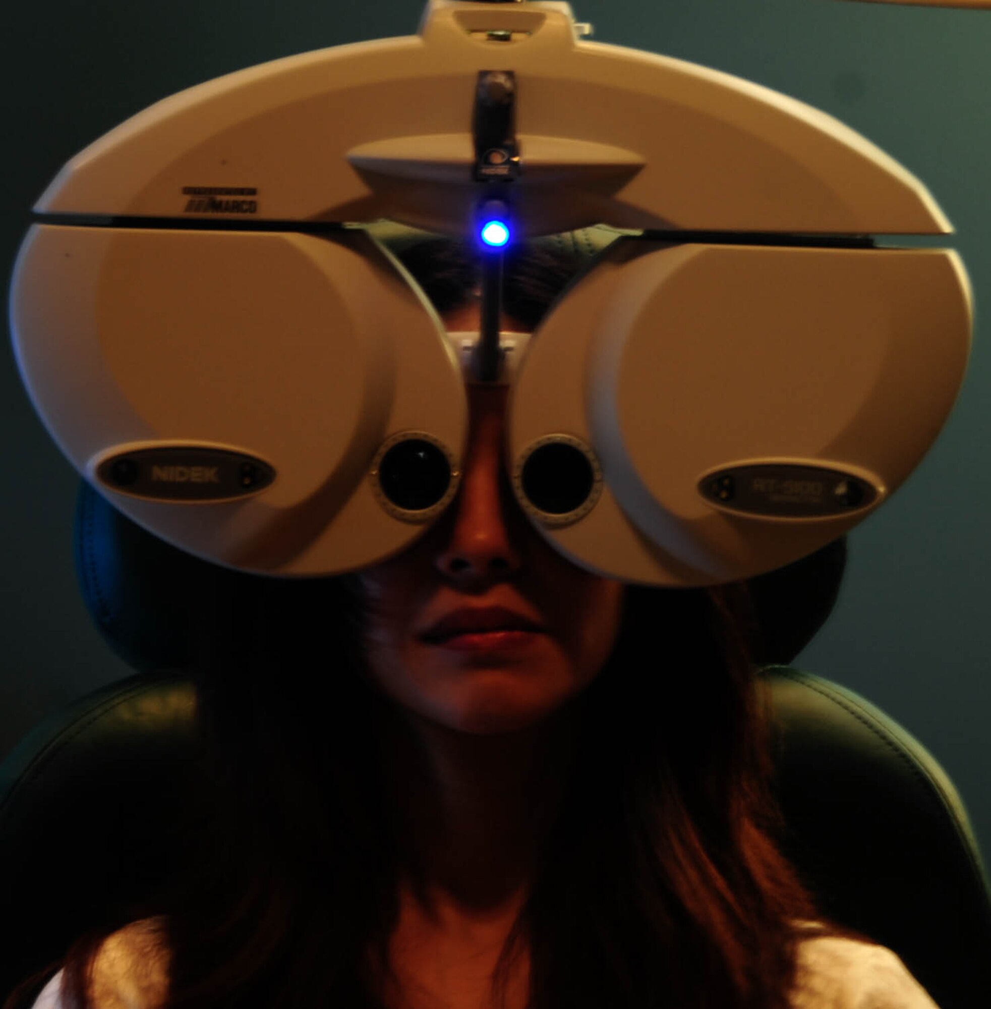 Chizu McCasland looks through a phoropter during an eye exam at Barksdale Air Force Base, La., Oct. 22, 2015. The phoropter contains different lenses for each eye, which helps the optometrist find the correct prescription for a patient. (U.S. Air Force photo/Staff Sergeant Jason McCasland)