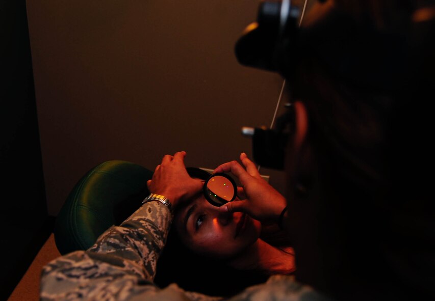 Capt. Shirley De La Rosa, 2nd Aerospace Medical Squadron Optometrist, conducts a Binocular Indirect Ophthalmoscopy, or BIO, on Chizu McCasland at Barksdale Air Force Base, La., Oct. 22, 2015. The BIO provided the optometrist a wider view of the retina and vitreous through a dilated pupil. Using this technique, they diagnose the health of the interior of an eye. (U.S. Air Force photo/Staff Sgt. Jason McCasland) 