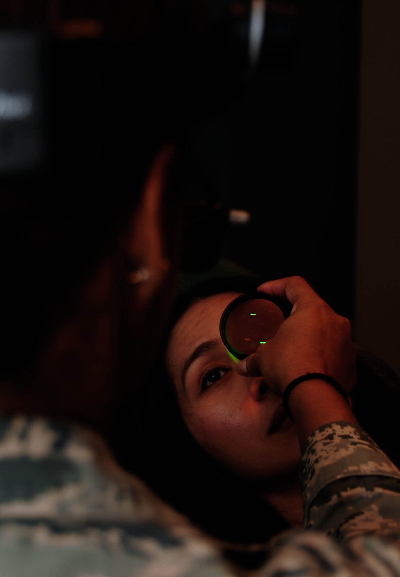 Capt. Shirley De La Rosa, 2nd Aerospace Medical Squadron Optometrist, conducts a Binocular Indirect Ophthalmoscopy, or BIO, on Chizu McCasland at Barksdale Air Force Base, La., Oct. 22, 2015. The BIO provided the optometrist a wider view of the retina and vitreous through a dilated pupil. Using this technique, they diagnose the health of the interior of an eye. (U.S. Air Force photo/Staff Sgt. Jason McCasland) 
