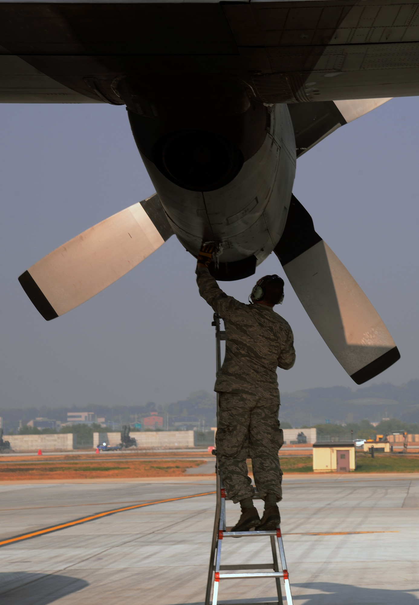 Air National Guard Staff Sgt. Michael Hoffman, 176th Aircraft Maintenance Squadron crew chief, Joint Base Elmendorf-Richardson, Alaska, wipes away residual oil from an HC-130 Combat King II cargo aircraft during a Vigilant Ace 16 aeromedical evacuation mission Nov. 5, 2015, at Osan Air Base, Republic of Korea. Vigilant Ace 16 is a peninsula-wide exercise designed to enhance combat capabilities and interoperability of the U.S. and Republic of Korea Air Forces. (U.S. Air Force photo/Staff Sgt. Benjamin Sutton)