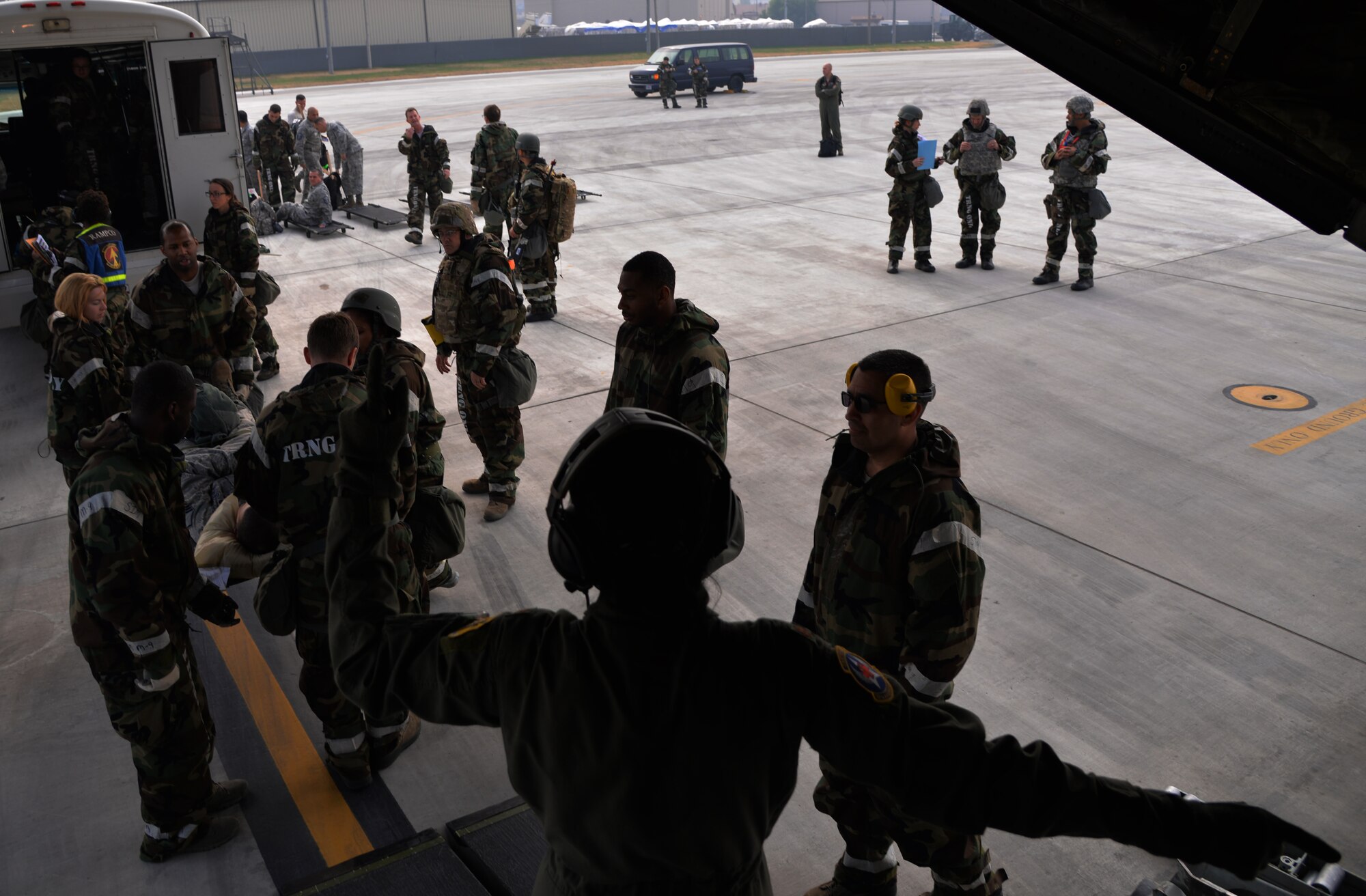 A member of the 18th Aeromedical Evacuation Squadron from Kadena Air Base, Japan, directs personnel from the 51st Medical Group participating in Vigilant Ace 16, to load a simulated casualty onto an HC-130 Combat King II cargo aircraft during an aeromedical evacuation Nov. 5, 2015, at Osan Air Base, Republic of Korea. During the large-scale exercise, a majority of Airmen are working 12-hour shifts in order to meet mission requirements. Vigilant Ace 16 is designed to enhance the interoperability of the U.S. and Republic of Korea Air Forces. (U.S. Air Force photo/Staff Sgt. Benjamin Sutton)