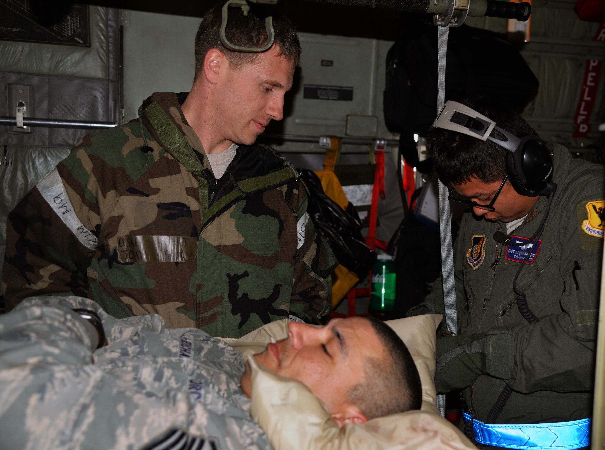 Capt. John Stacey, 36th Fighter Squadron flight surgeon, and Staff Sgt. Aldwin Gacote, 18th Aeromedical Evacuation Squadron technician from Kadena Air Base, Japan, strap down a patient during a Vigilant Ace 16 aeromedical evacuation Nov. 5, 2015, at Osan Air Base, Republic of Korea. More than eight squadrons from three seperate bases across Pacific Air Forces are participating in Vigilant Ace 16. Vigilant Ace 16 is a large-scale exercise designed to enhance the interoperability of the U.S. and Republic of Korea Air Forces. (U.S. Air Force photo/Staff Sgt. Benjamin Sutton)