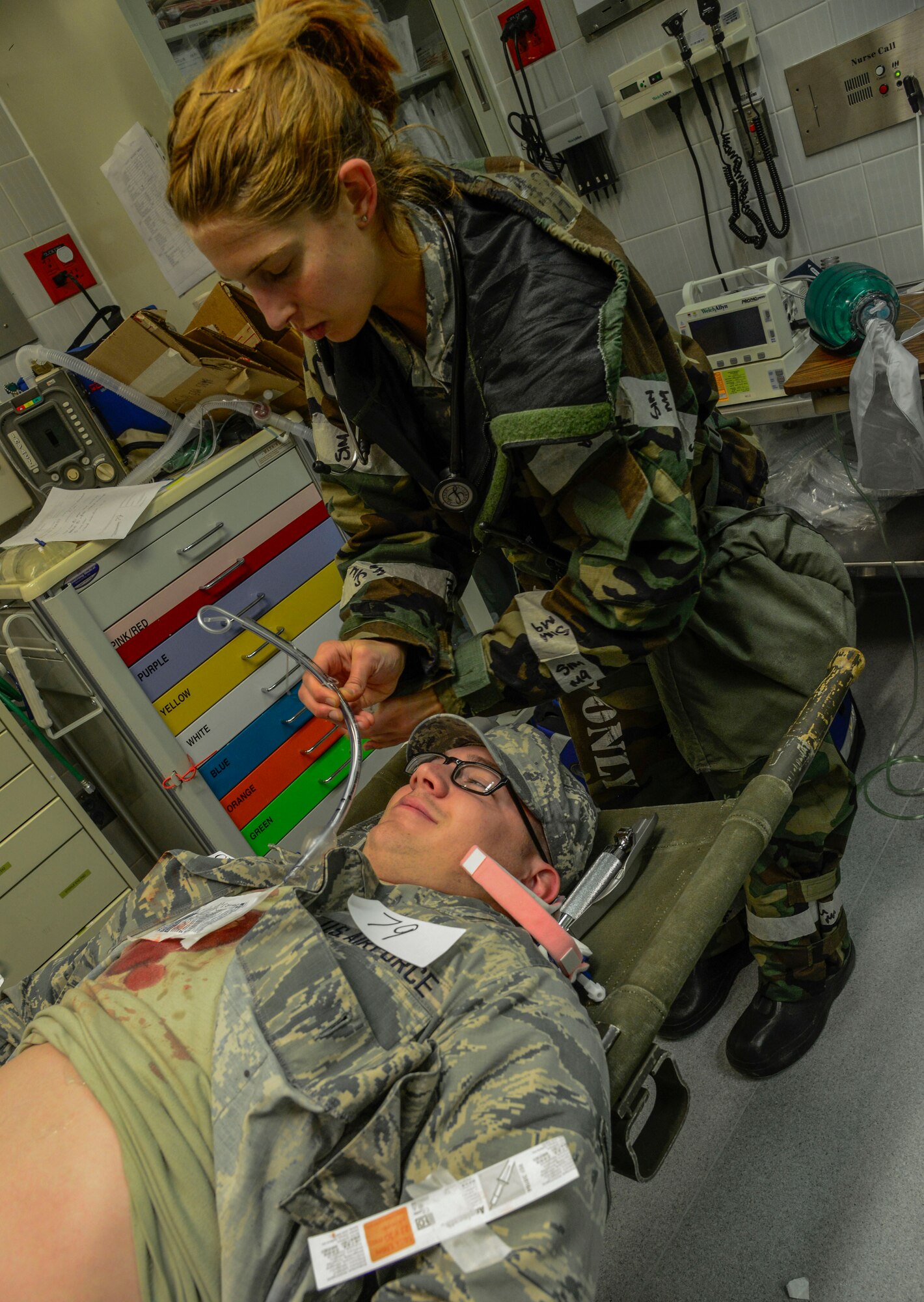Capt. Lauren Bosshardt, 51st Medical Operations Squadon physician, similates inserting a breathing tube in a patient during the Vigilant Ace 16 exercise on Osan Air Base, Republic of Korea, Nov. 3, 2015. Throughout the exercise, the MDOS Airmen will be tested on various role-players who have assigned injuries. Each role player is given a number and a detailed card stating the severity of their injuries. Doctors and nurses along with medical technicians evaluate the simulated patients as they would in real life, in an effort to save the exercise player. (U.S. Air Force photo/Senior Airman Kristin High)