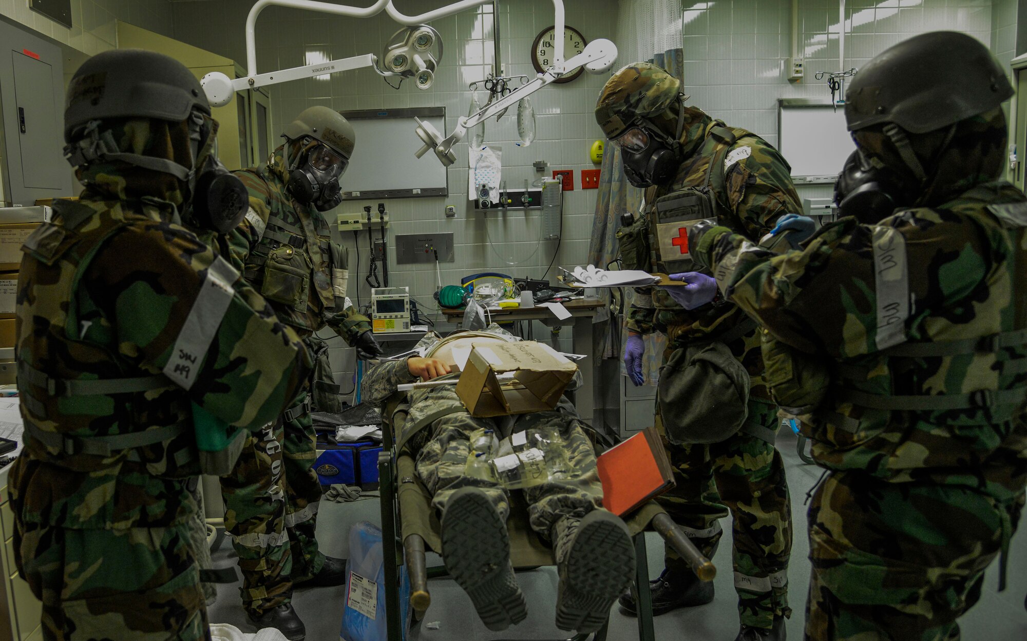 Airmen from the 51st Medical Operations Squadron continue to simulate patient care in protective equipment during the Vigilant Ace 16 exercise on Osan Air Base, Republic of Korea, Nov. 3, 2015. The exercise is a combined operation between ROK and U.S. forces designed to enhance the alliance between the two countries. The MDOS participates in Vigilant Ace 16 to help learn vital skills needed in the event of real-world contingencies. This exercise allows the MDOS Airmen to train in mission oriented  protective posture, or MOPP, gear along with actively role-playing with simulated patients. (U.S. Air Force photo/Senior Airman Kristin High)
