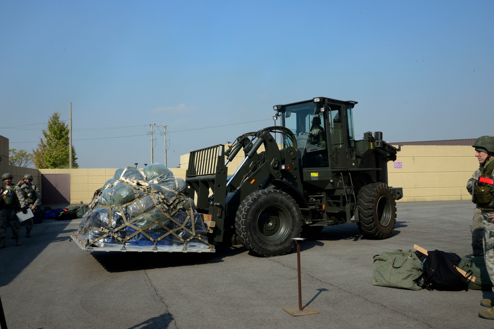 An Airman from the 51st Logistics Readiness Squadron moves a pallet of baggage during the Vigilant Ace 16 exercise on Osan Air Base, Republic of Korea, Nov. 2, 2015. The peninsula-wide exercise is combined between the ROK and U.S. forces with more than 16,000 personnel to practice training scenarios and mission readiness while strengthening the bond between the two nations. (U.S. Air Force photo/Senior Airman Kristin High)