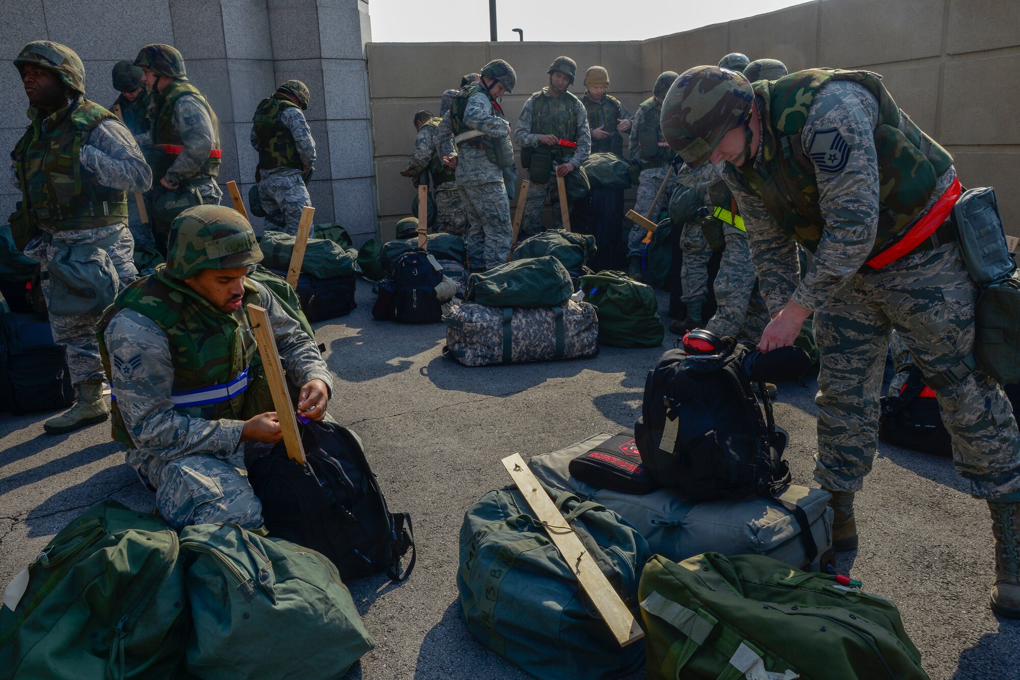 Augmentee Airmen from the 35th Fighter Wing, Misawa Air Base, Japan, arrive to participate in the Vigilant Ace 16 exercise on Osan Air Base, Republic of Korea, Nov. 2, 2015. The Airmen were among more than 1,000 personnel to deploy to the peninsula to assist in the largest exercise in the ROK held annually to practice training scenarios and mission readiness. The week-long exercise greatly benefits the combined military readiness of the ROK and U.S. by allowing military personnel the opportunity to work side-by-side to integrate air operations more effectively. (U.S. Air Force photo/Senior Airman Kristin High)
