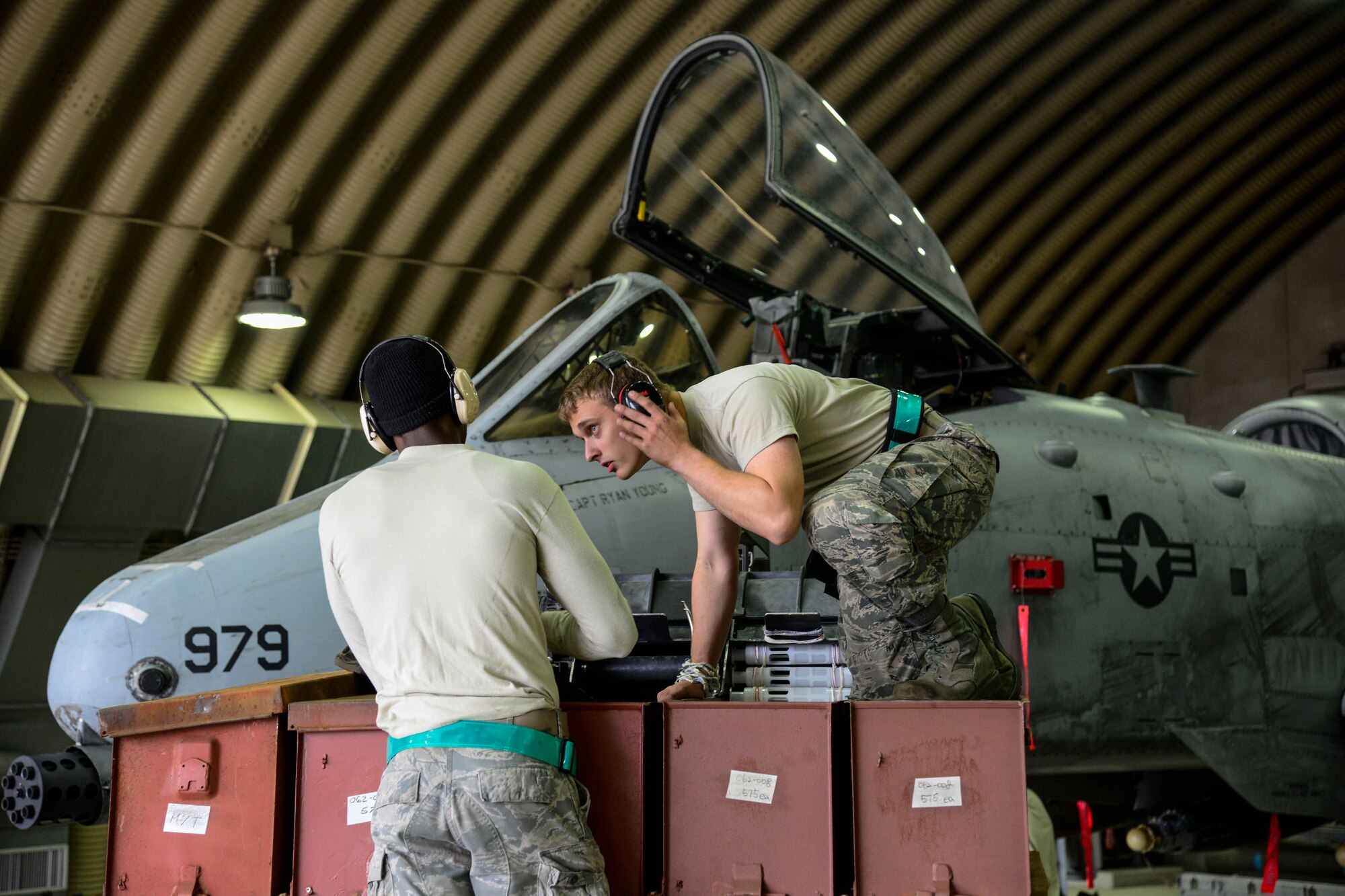 Senior Airman Kameron Whitener and Airman 1st Class Brandon Jones, 25th Aircraft Maintenance Unit weapons load crew team members, prepare to load 30 millimeter rounds onto an A-10 Thunderbolt II during the Vigilant Ace 16 exercise on Osan Air Base, Republic of Korea, Nov. 1, 2015. Each team has three Airmen who are all responsible for different portions of the load. The one-man is the supervisor, the two-man is responsible for tools and aircraft preparation and the three-man is responsible for driving the jammer and munitions preparation. Without each member, the crews would not be able to properly load munitions in the safest way possible. (U.S. Air Force photo/Senior Airman Kristin High)