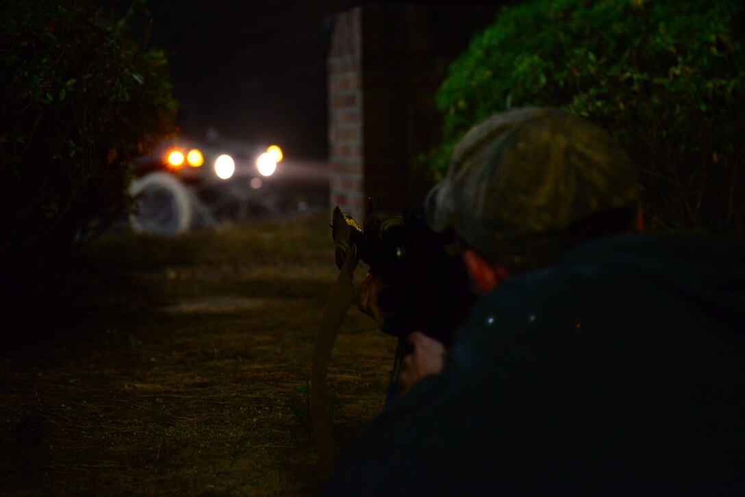 Airman 1st Class Jacob Hilley, 51st Security Forces Squadron member, acting as opposing forces, waits to fire on base defenders responding as reinforcements during exercise Vigilant Ace 16 at Osan Air Base, Republic of Korea, Nov. 5, 2015. Ground attacks on defensive fighting positions are a large part of testing the operational and tactical levels of coordination for the base. (U.S. Air Force photo/Staff Sgt. Amber Grimm)