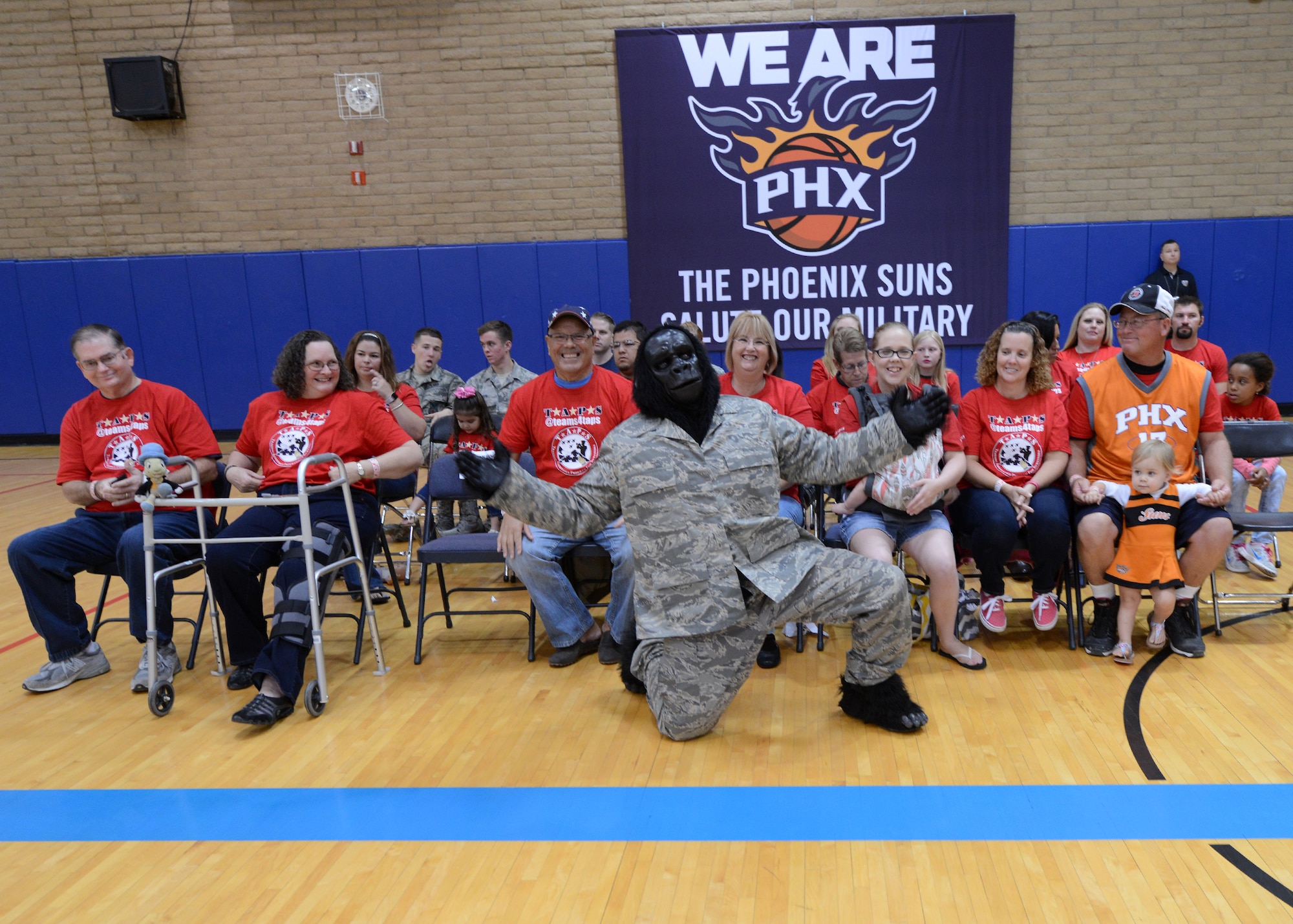 “Go” the gorilla poses with families of fallen heroes November 5, 2015, at Luke Air Force Base, Arizona. Families were escorted by each play of the Phoenix Suns during the practice event held at the Bryant Fitness Center. (U.S. Air Force photo by Staff Sgt. Marcy Copeland)