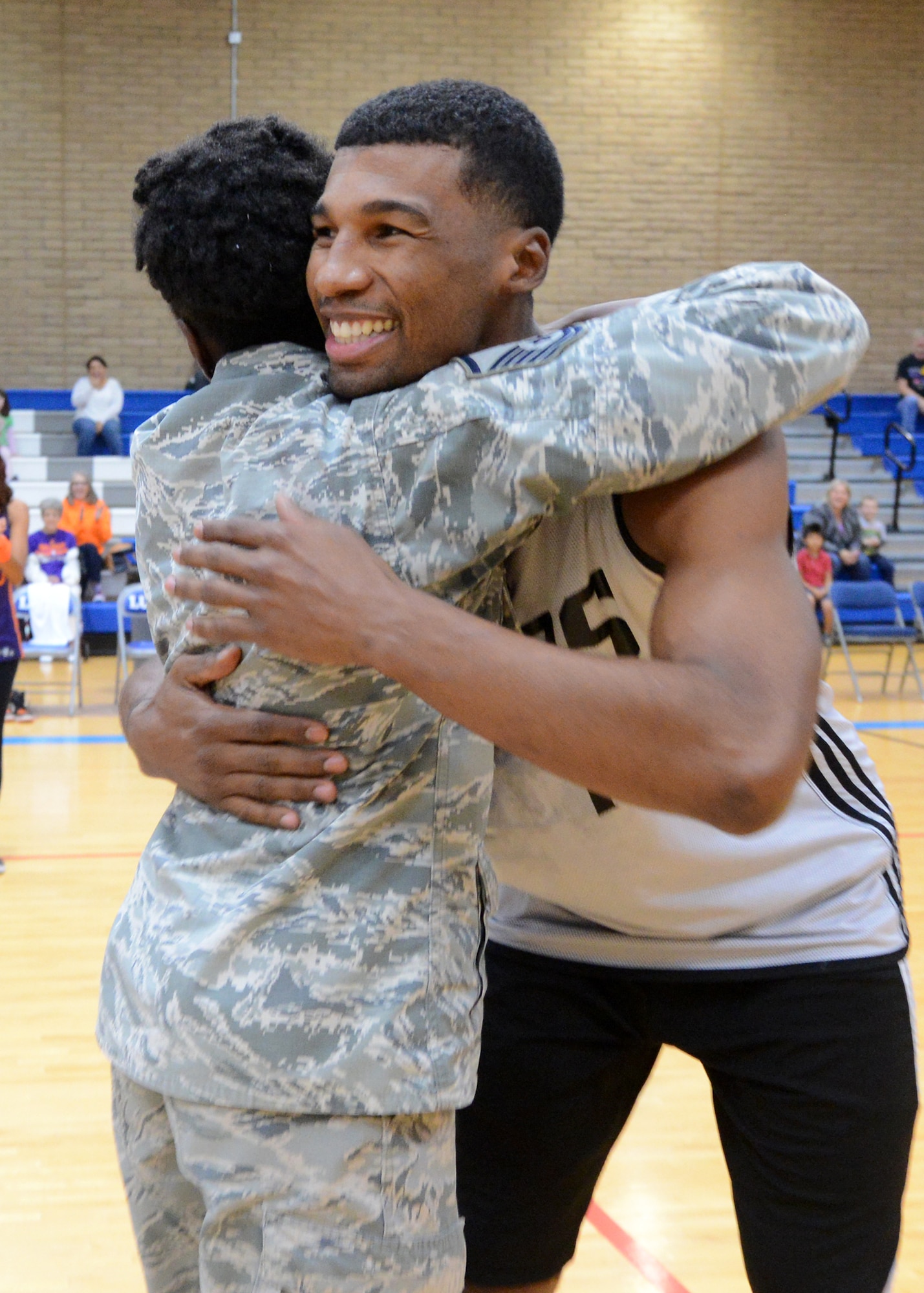 Ronnie Price, Phoenix Suns guard, hugs Master Sgt. Fencl, 56th Force Support Squadron superintendent, after winning her a signed jersey November 5, 2015, on Luke Air Force Base, Arizona. Players were matched to Airmen and had to make a shot from half court to win the Airmen a personally signed jersey.  (U.S. Air Force photo by Staff Sgt. Marcy Copeland)