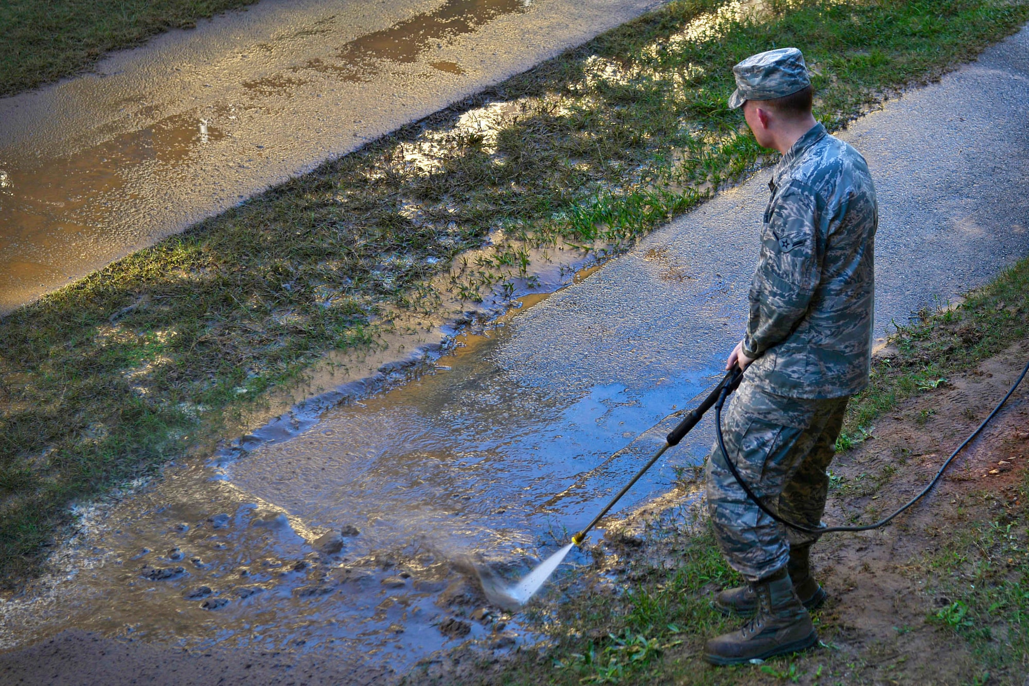 A U.S. Airman uses a pressure washer to clean a sidewalk during a dorm cleanup event at Shaw Air Force Base, S.C., Oct. 30, 2015. Base leadership and supervisors helped Airmen clean and perform minor maintenance to ensure their dorms were in a functioning manner. (U.S Air Force photo by Airman 1st Class Christopher Maldonado)