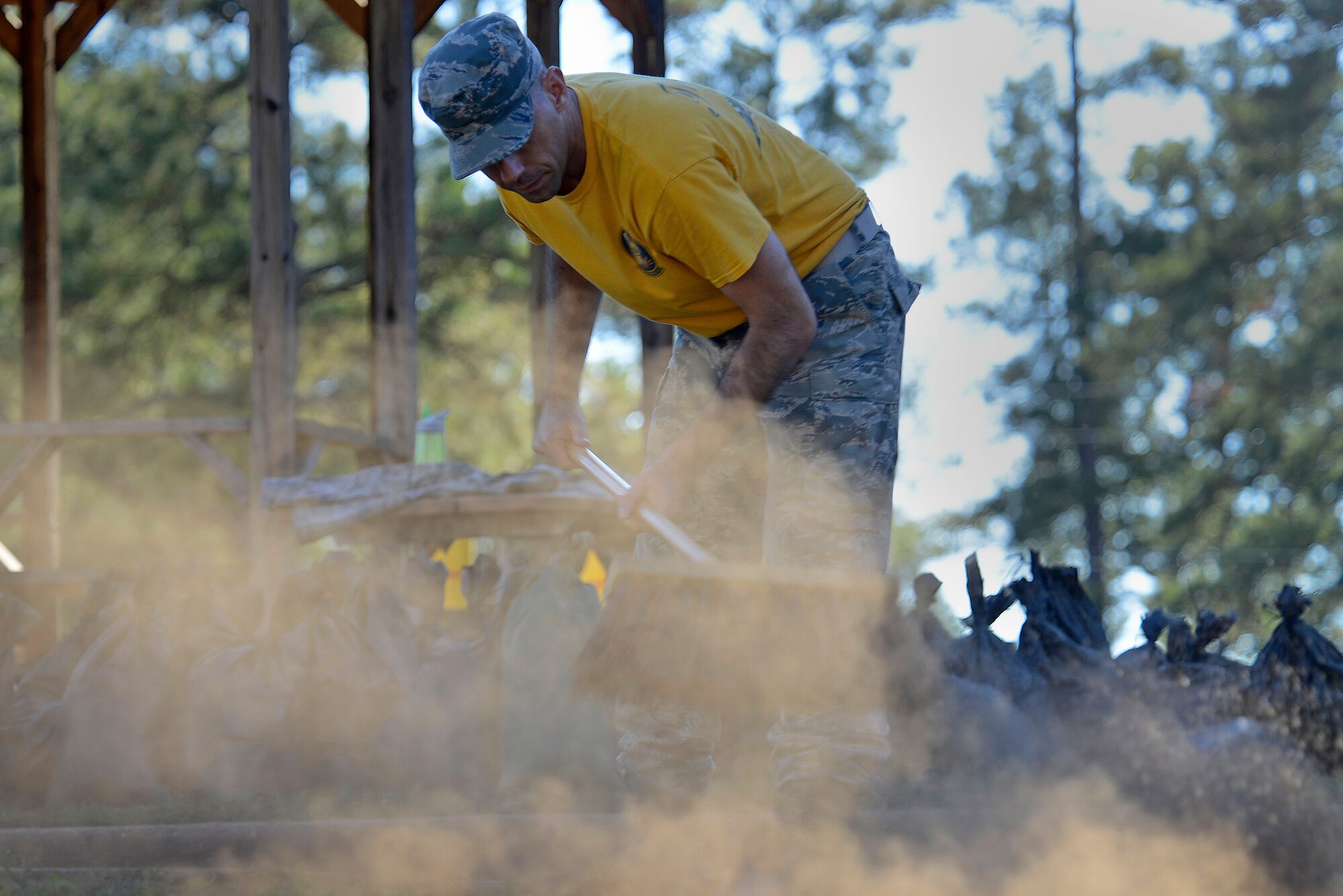 A U.S. Airman uses a platform broom to clear dirt off a sidewalk during a dorm cleanup event at Shaw Air Force Base, S.C., Oct. 30, 2015. Throughout the event Airmen power-washed sidewalks, pulled weeds, and removed dead brush from around the nine dorms. (U.S Air Force photo by Airman 1st Class Christopher Maldonado)