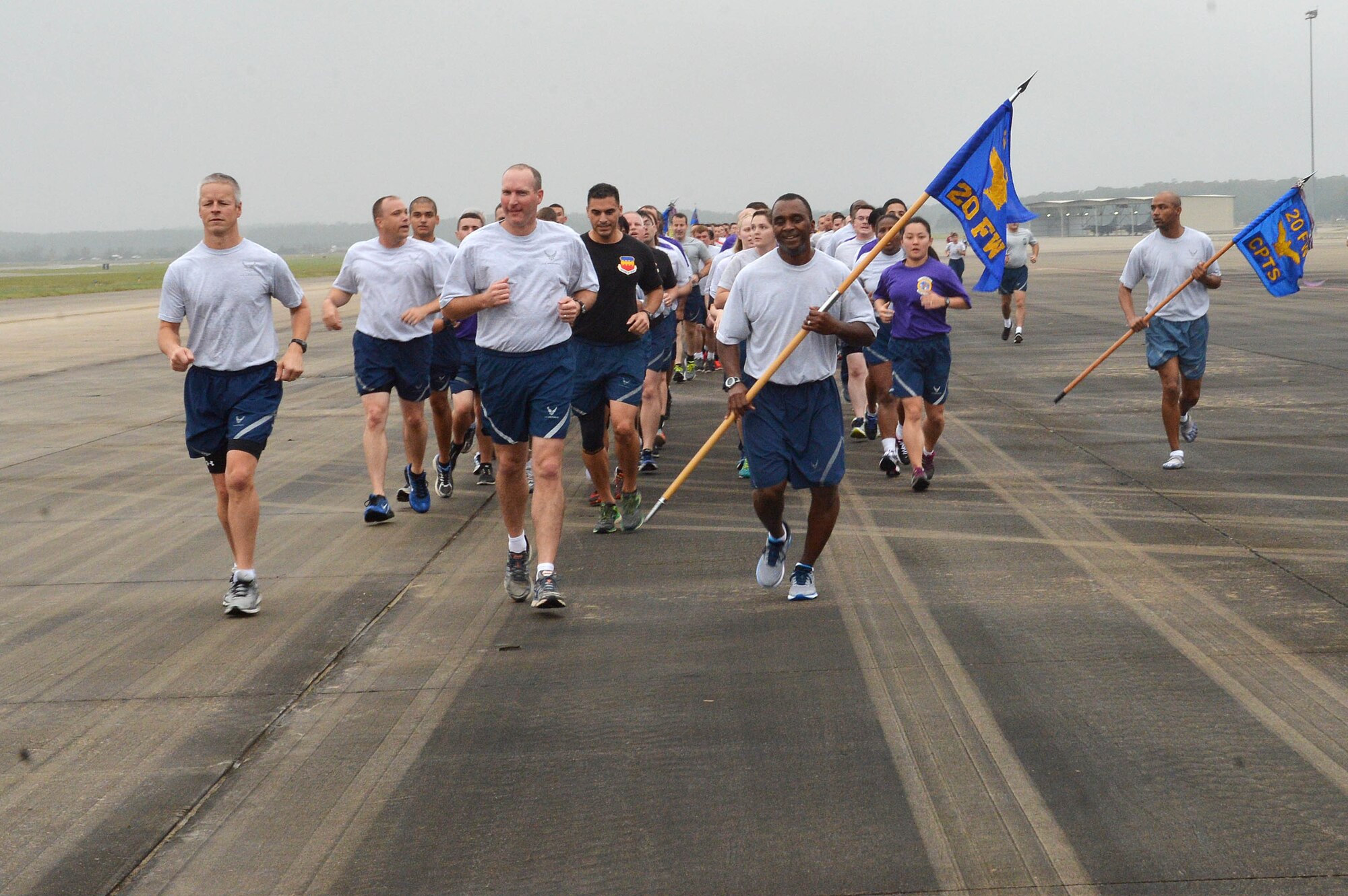 U.S. Airmen run down the taxiway during a 20th Fighter Wing Airman’s run at Shaw Air Force Base, S.C., Nov. 6, 2015. The morale-building event was labeled “Back to the Basics” and was aimed to strengthen unity and cohesion within 20th FW. (U.S. Air Force photo by Senior Airman Diana Cossaboom)