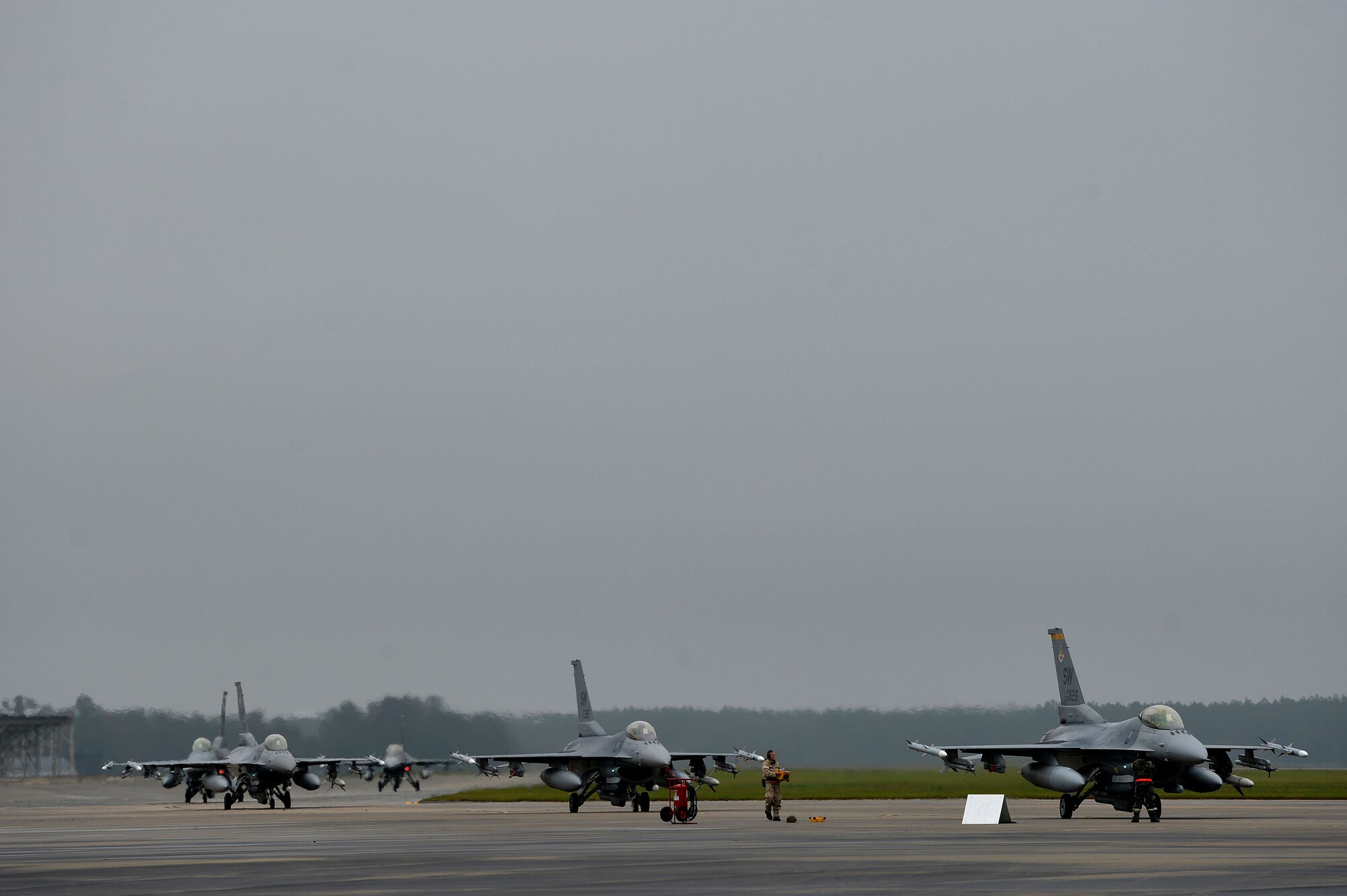 U.S. Air Force F-16CM Fighting Falcons assigned to the 20th Fighter Wing taxi to the end of the runway during operational readiness exercise Weasel Victory 16-02, at Shaw Air Force Base, S.C., Nov. 3, 2015. Throughout the exercise the 20th FW was evaluated on its combat capabilities and readiness. (U.S. Air Force photos by Senior Airman Michael Cossaboom)