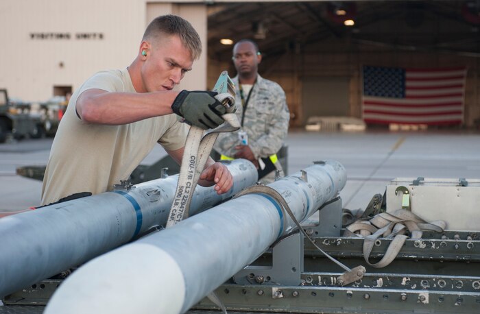 Staff Sgt. Colton Covill, Eagle Aircraft Maintanence Unit weapons team chief,  readies a munition during a quarterly weapons load crew competition on Nellis Air Force Base, Nev., Oct. 23, 2015. Weapons loaders load various types of munitions to the specific aircraft to which they are assigned. (U.S. Air Force photo by Senior Airman Mikaley Kline) 