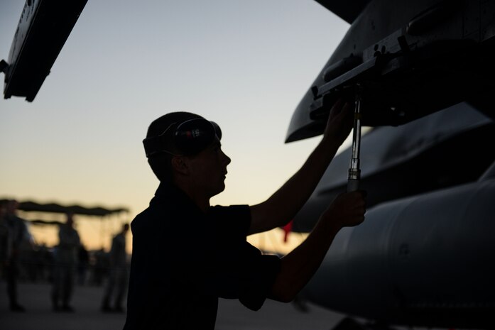 Airman 1st Class Andrew Thompson, Tomahawk Aircraft Maintanence Unit weapons load crew member, prepares to load a munition during a quarterly weapons load crew competition on Nellis Air Force Base, Nev., Oct. 23, 2015. Load crew competitions are held to provide weapons personnel the opportunity to display their war-fighting skills and to unveil the best weapons load crew. (U.S. Air Force photo by Airman 1st Class Rachel Loftis) 