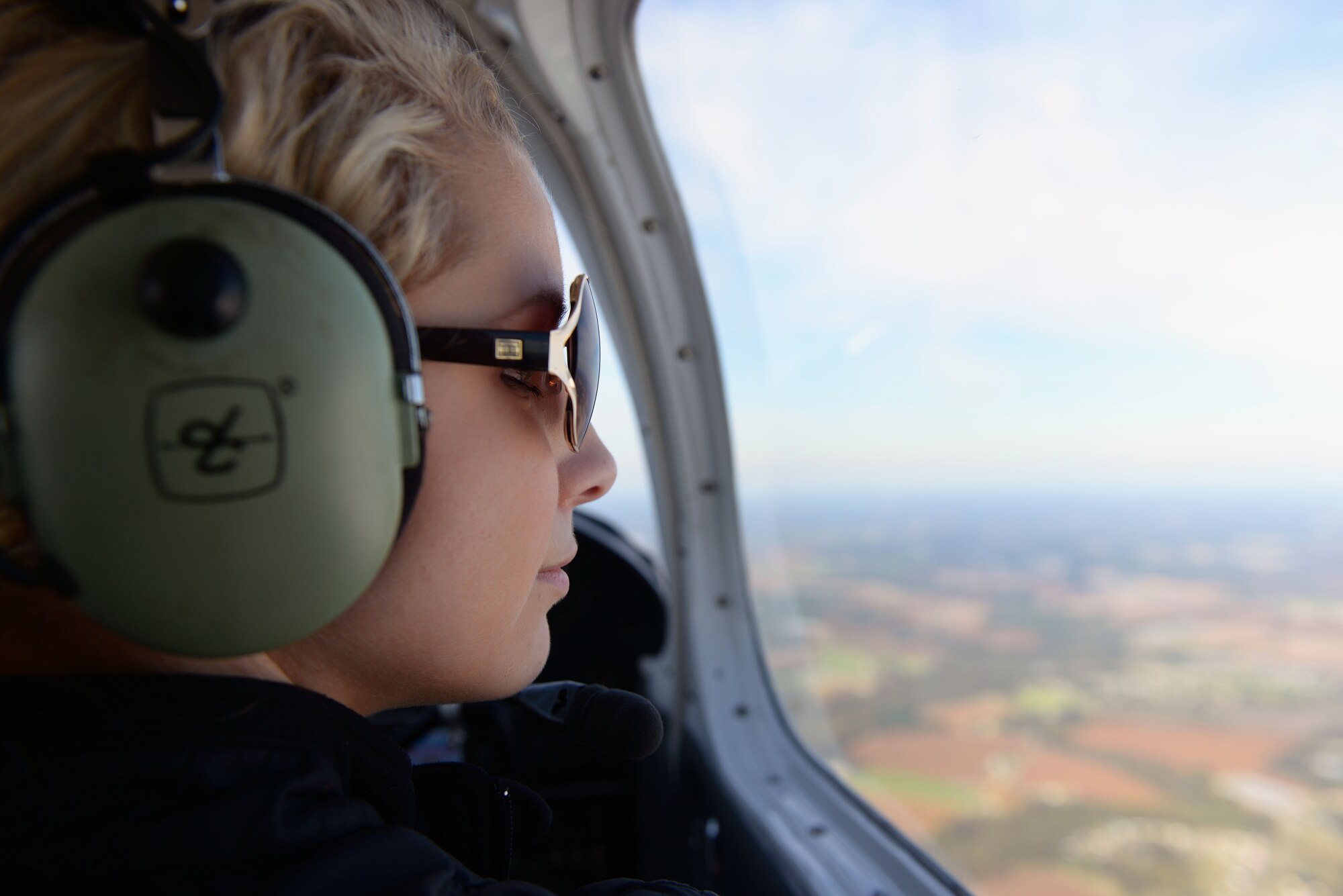 Airman 1st Class Austyn Tabor, 4th Operations Support Squadron air traffic controller, observes the surrounding area during the Scare-A-Controller event, Oct. 31, 2015, over Kinston, North Carolina. The flights lasted about 50 minutes each and went around Wayne and Johnston Counties. (U.S. Air Force photo/Senior Airman John Nieves Camacho)