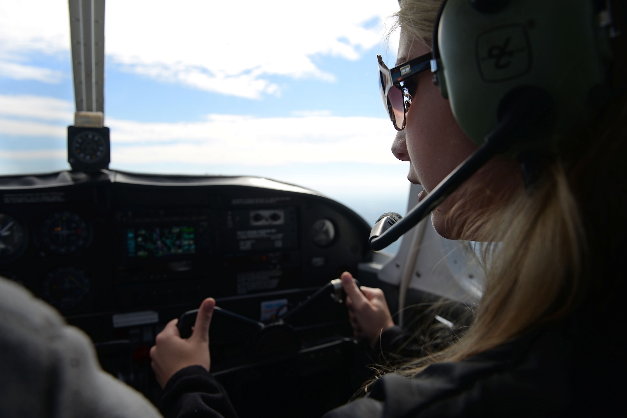 Airman 1st Class Austyn Tabor, 4th Operations Support Squadron air traffic controller, pilots an aircraft during the Scare-A-Controller event, Oct. 31, 2015, over Goldsboro, North Carolina. The flight took Airmen on a tour of the local eastern North Carolina region including passes over Kinston, a low approach over Seymour Johnson Air Force Base, then west to Johnston County before returning to Goldsboro. (U.S. Air Force photo/Senior Airman John Nieves Camacho)