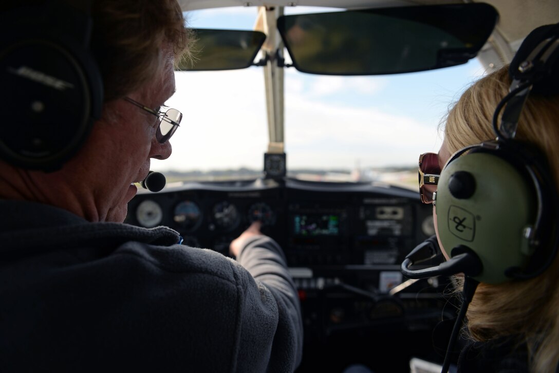Dave Williams (left) explains aircraft mechanics to Airman 1st Class Austyn Tabor, 4th Operations Support Squadron air traffic controller, during the Scare-A-Controller event, Oct. 31, 2015, at Wayne Executive Jetport in Goldsboro, North Carolina. Williams talked about different aviation functions, flight stressors and procedures. (U.S. Air Force photo/Senior Airman John Nieves Camacho)