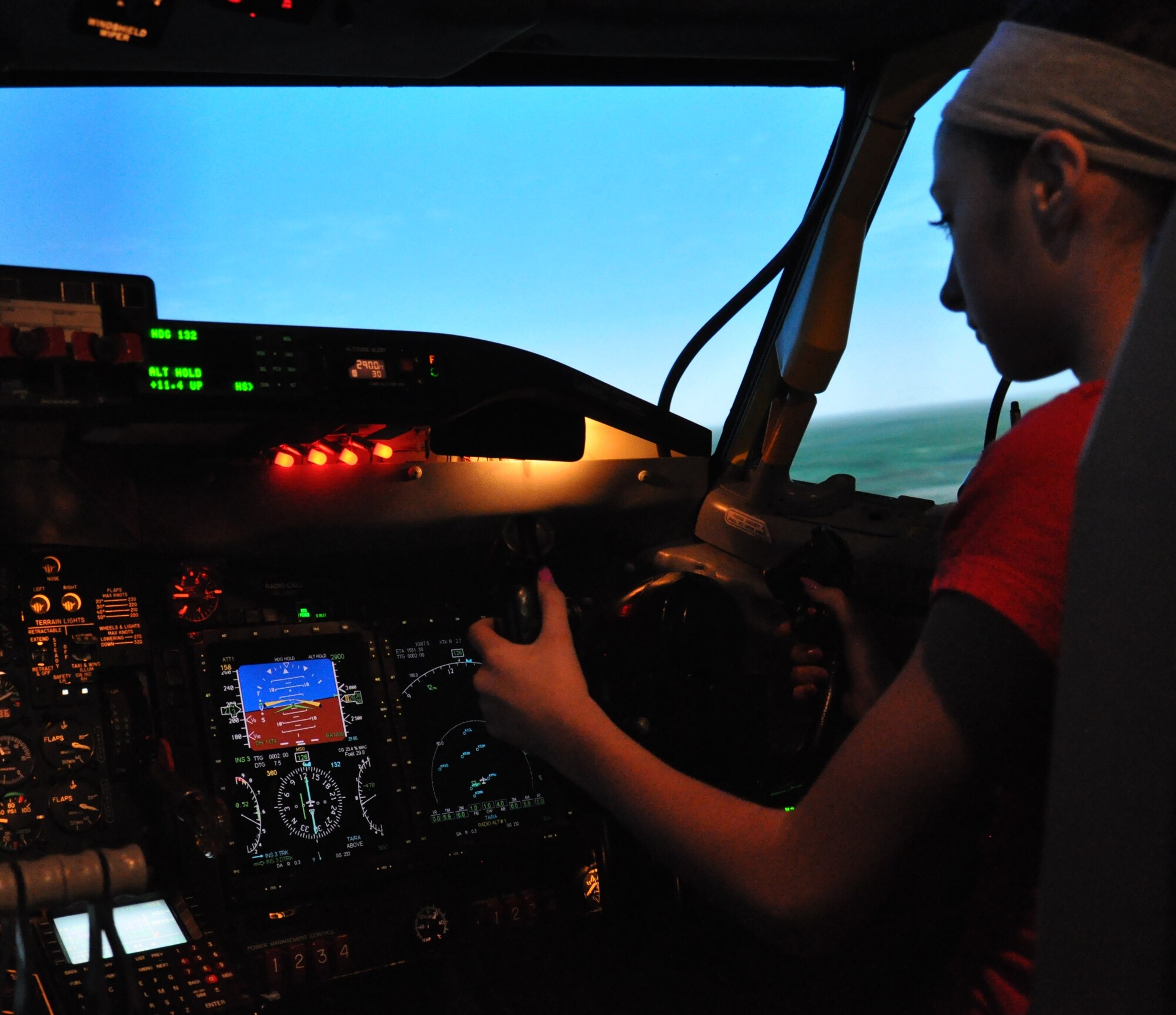 Mollee Francis, a seventh grader from Alfonza W. Davis Middle School in Omaha, Neb., flies an RC-135 OFT simulator at Offutt Air Force Base Nov. 3, 2015. The program, coordinated through the Alfonza W. Davis Chapter of Tuskegee Airmen Incorporated, hopes to encourage middle school students to form an interest in the STEM subjects. (U.S. Air Force photo by Senior Airman Rachel Hammes)
