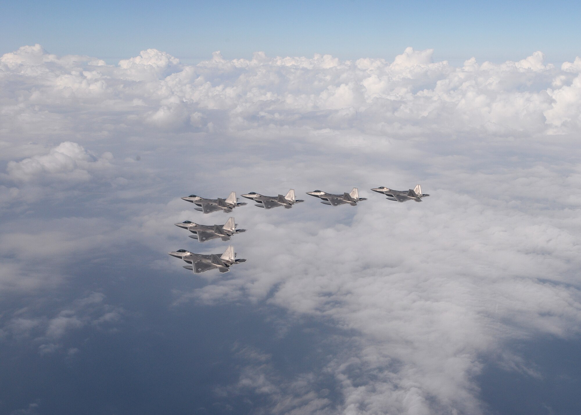Six F-22 Raptors from the 95th Fighter Squadron from Tyndall Air Force Base, Fla., fly over the Gulf of Mexico Nov. 5 during a local training mission. The group of six F-22s were part of a large group formation of 15 Raptors. (U.S Air Force photo by Tech. Sgt. Burt Traynor/Released)