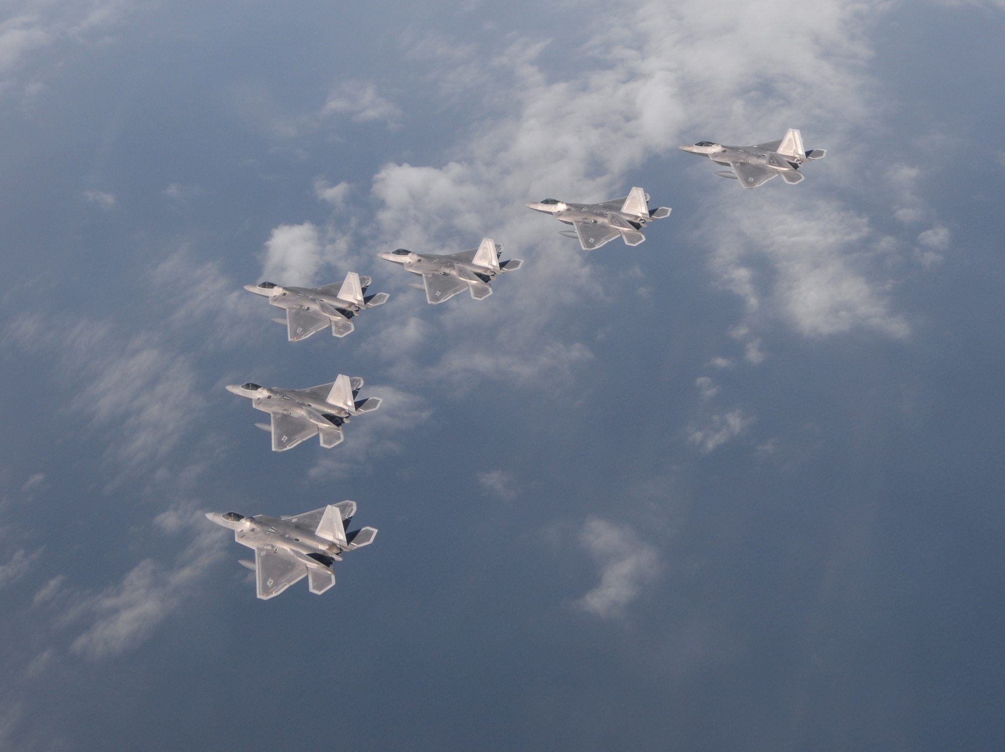 Six F-22 Raptors from the 95th Fighter Squadron from Tyndall Air Force Base, Fla., fly over the Gulf of Mexico Nov. 5 during a local training mission. The group of six F-22s were part of a large group formation of 15 Raptors. (U.S Air Force photo by Tech. Sgt. Burt Traynor/Released)