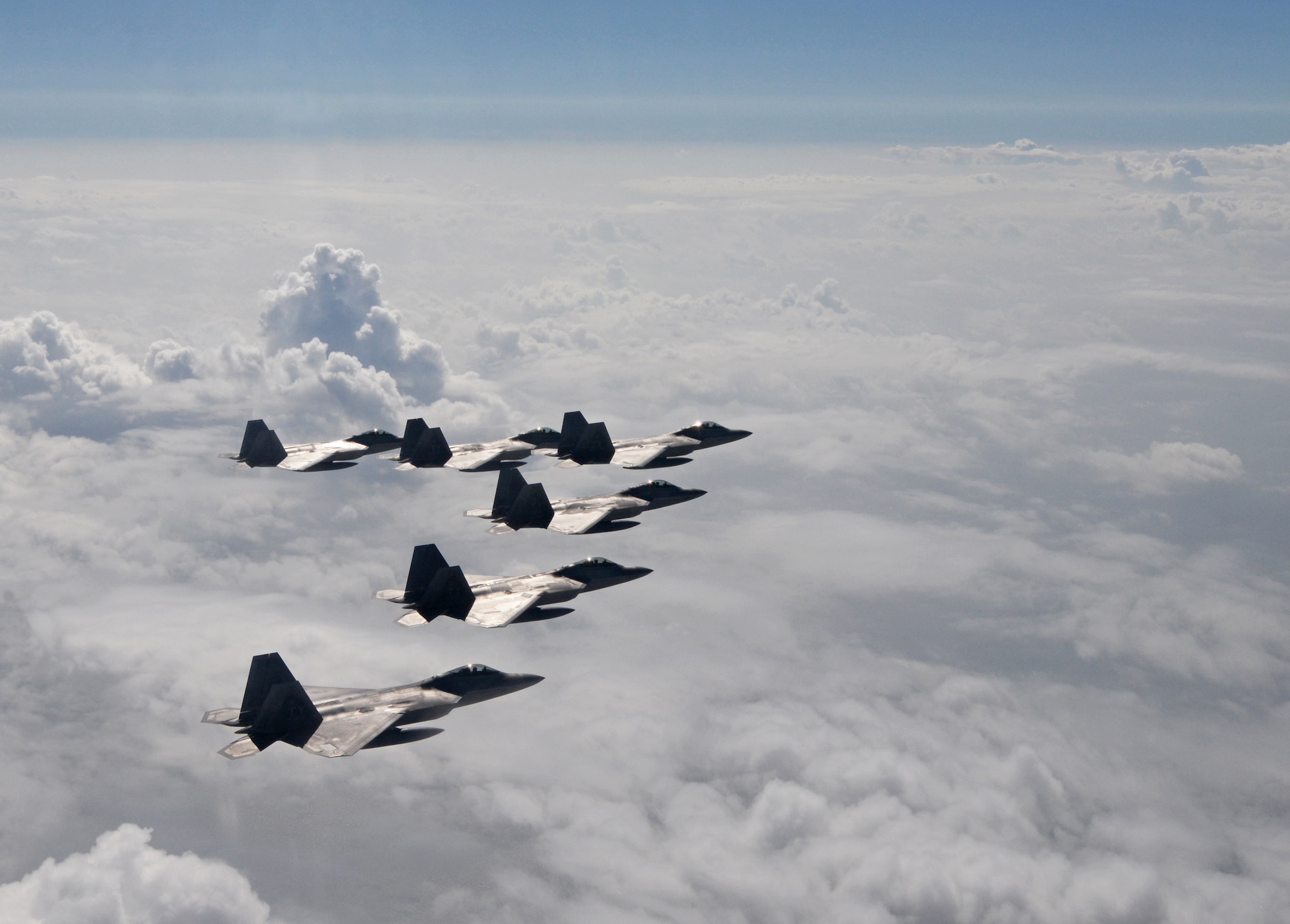 Six F-22 Raptors from the 95th Fighter Squadron from Tyndall Air Force Base, Fla., fly over the Gulf of Mexico Nov. 5 during a local training mission. The group of six F-22s were part of a large group formation of 15 Raptors. (U.S Air Force photo by Tech. Sgt. Burt Traynor/Released)