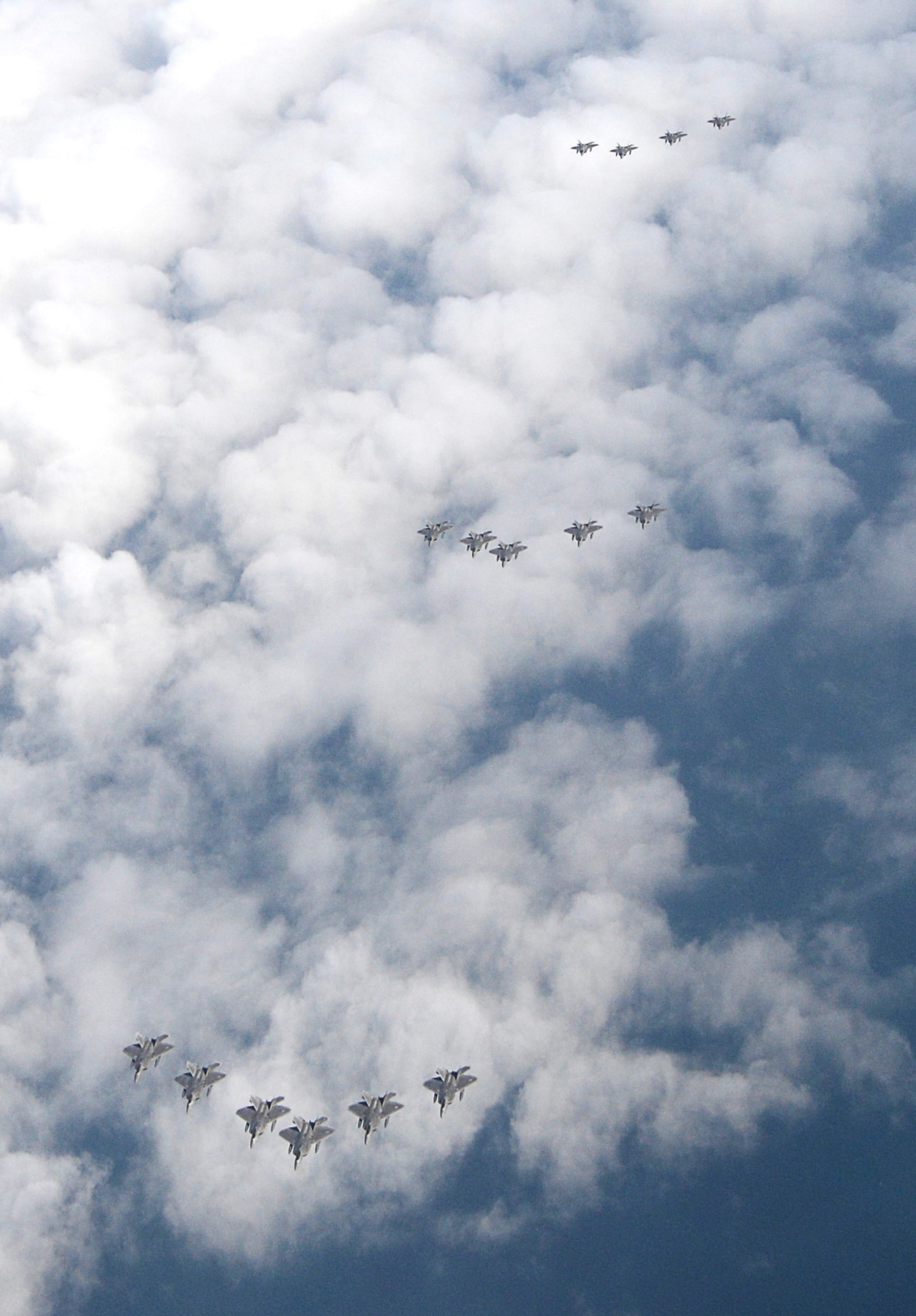 A formation of 15 95th Fighter Squadron F-22 Raptors from Tyndall Air Force Base, Fla., fly over the Gulf of Mexico Nov. 5 during a local training mission. The 95th FS is part of the 325th Fighter Wing whose primary mission is to train and project unrivaled combat air power for F-22 pilots and maintenance personnel to support the combat Air Forces. (U.S Air Force photo by Tech. Sgt. Burt Traynor/Released)
