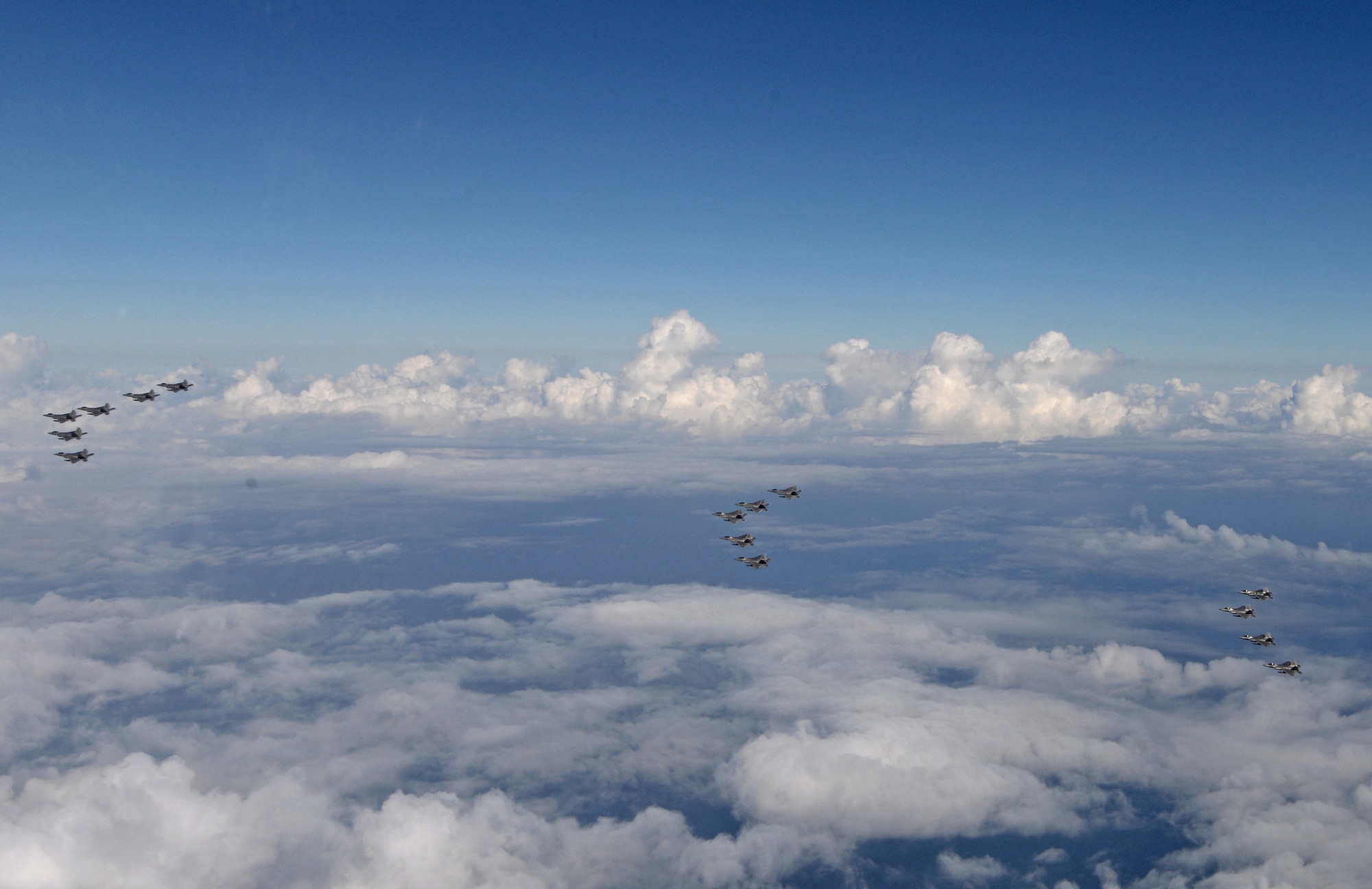 A formation of 15 95th Fighter Squadron F-22 Raptors from Tyndall Air Force Base, Fla., fly over the Gulf of Mexico Nov. 5 during a local training mission. The 95th FS is part of the 325th Fighter Wing whose primary mission is to train and project unrivaled combat air power for F-22 pilots and maintenance personnel to support the combat Air Forces. (U.S Air Force photo by Tech. Sgt. Burt Traynor/Released)