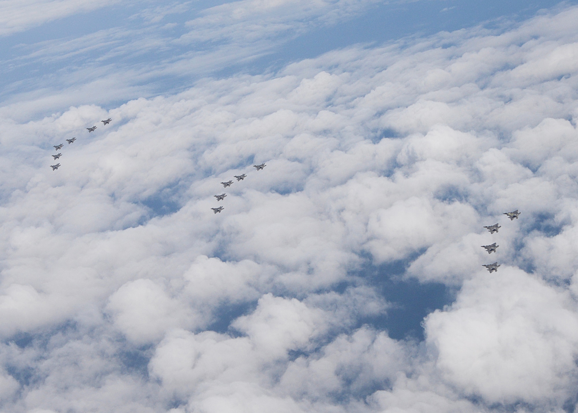 A formation of 15 95th Fighter Squadron F-22 Raptors from Tyndall Air Force Base, Fla., fly over the Gulf of Mexico Nov. 5 during a local training mission. The 95th FS is part of the 325th Fighter Wing whose primary mission is to train and project unrivaled combat air power for F-22 pilots and maintenance personnel to support the combat Air Forces. (U.S Air Force photo by Tech. Sgt. Burt Traynor/Released)