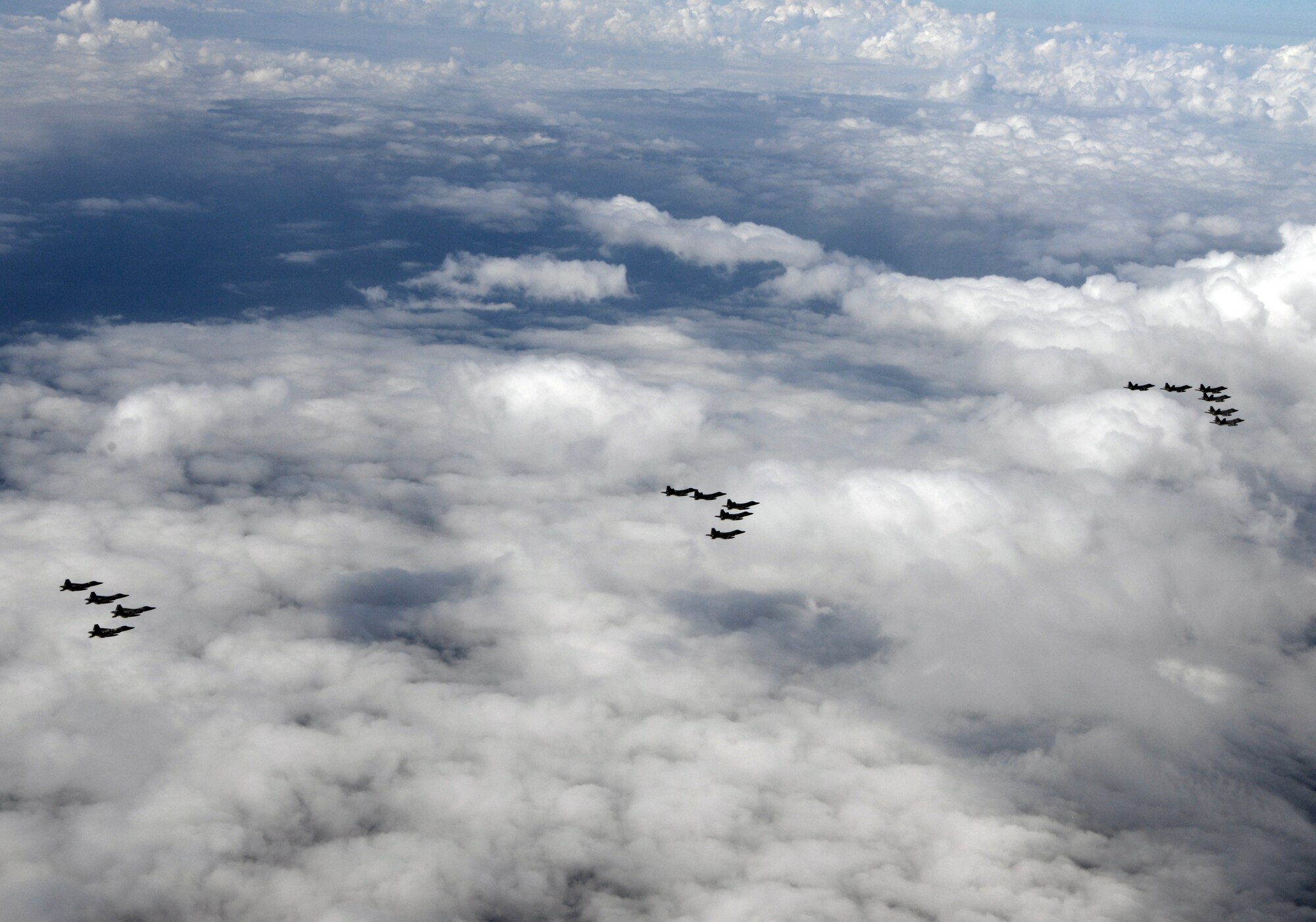 A formation of 15 95th Fighter Squadron F-22 Raptors from Tyndall Air Force Base, Fla., fly over the Gulf of Mexico Nov. 5 during a local training mission. The 95th FS is part of the 325th Fighter Wing whose primary mission is to train and project unrivaled combat air power for F-22 pilots and maintenance personnel to support the combat Air Forces. (U.S Air Force photo by Tech. Sgt. Burt Traynor/Released)