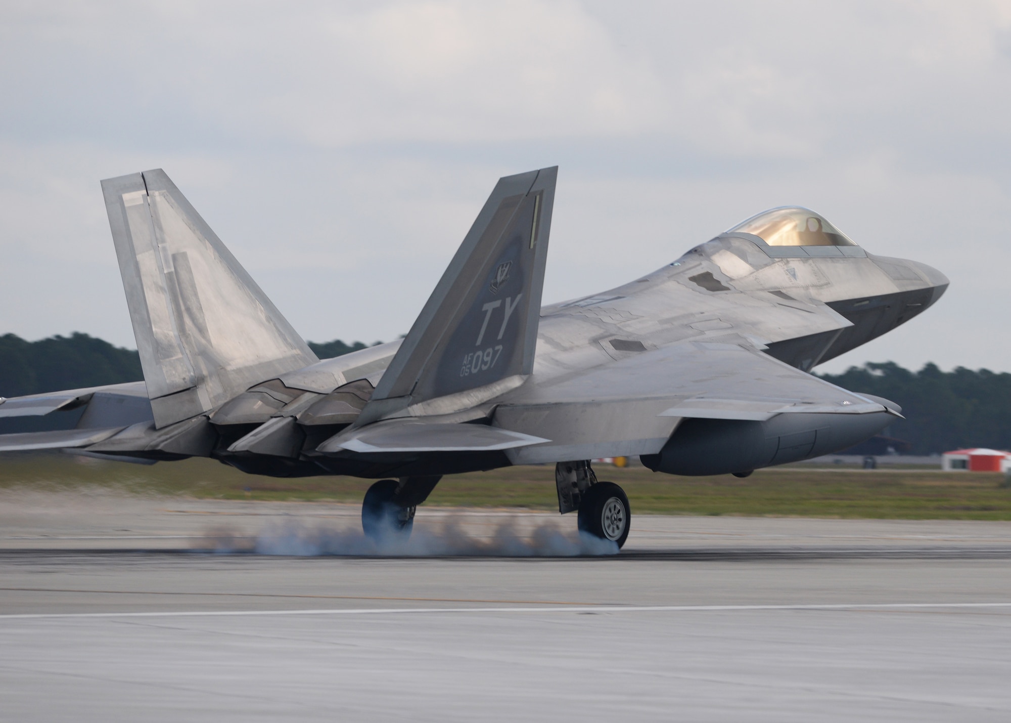 An F-22 Raptor from Tyndall Air Force Base, Fla., touches down Nov. 5 at the Tyndall flightline. The F-22 Raptor's combination of stealth, supercruise, maneuverability and integrated avionics, coupled with improved supportability, represents an exponential leap in warfighting capabilities and allows for the full realization of operational concepts that are vital to the 21st century Air Force. (U.S. Air Force photo by Senior Airman Sergio A. Gamboa/Released)
