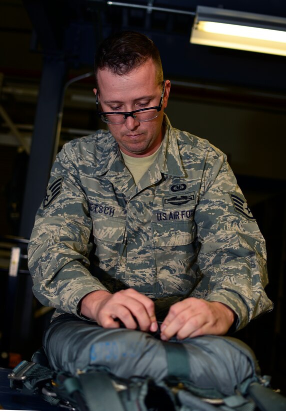 Staff Sgt. Jason Pietsch, airborne flight equipment, 328th Airlift Squadron, prepares a parachute on Oct. 18, 2015 at the Niagara Falls Air Reserve Station. Pietsch is responsible for all aircrew equipment such as: parachutes, survival kits, emergency oxygen and helmets. (U.S Air Force photo by Tech. Sgt. Stephanie Sawyer)