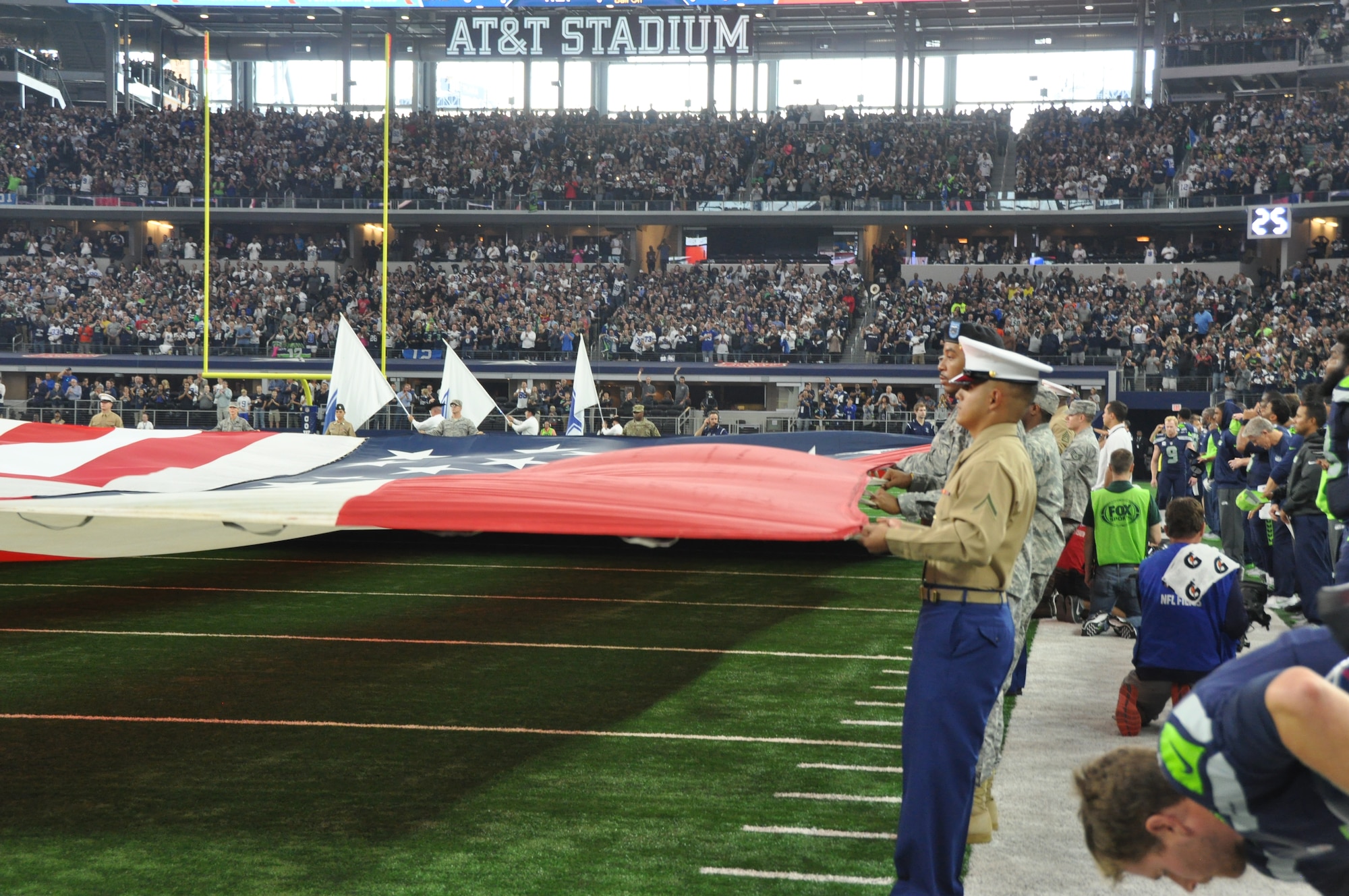 Nearly 70 military service members took to the field during the national anthem to display the American flag for those attending the Dallas Cowboys game on Nov. 1, 2015, against the Seattle Seahawks at AT&T Stadium in Arlington, Texas. The Seahawks took the 13-12 win in a close game. (Air Force photo/Master Sgt. Julie Briden-Garcia)