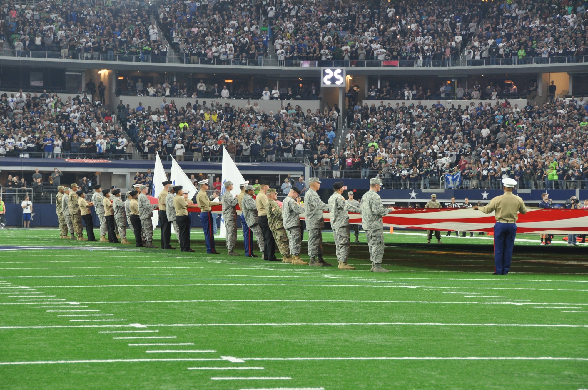 During the national anthem, 65 military service members took to the field to display the American flag for those attending the Dallas Cowboys game on Nov. 1, 2015, against the Seattle Seahawks at AT&T Stadium in Arlington, Texas. The Seahawks took the 13-12 win in a close game. (Air Force photo/Master Sgt. Julie Briden-Garcia)