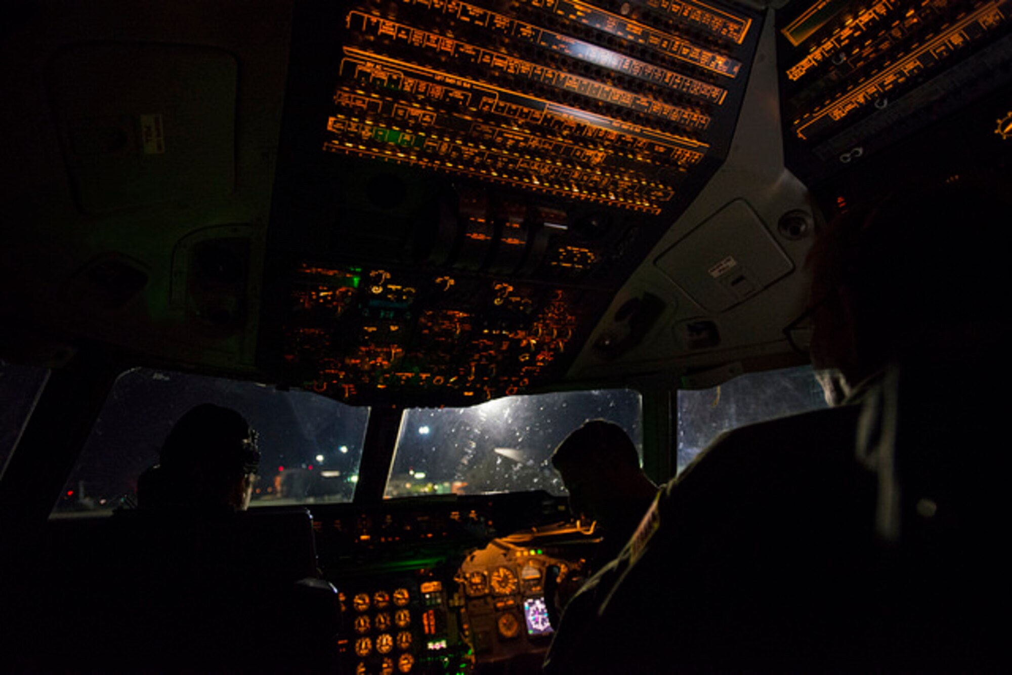 The crew of a 6th Air Refueling Squadron KC-10 Extender from Travis Air Force Base, Cali. work in unison while flying over the Atlantic Ocean during  Exercise Ultimate Reach, Nov. 4, 2015. The mission involved eight KC-10s meeting seven C-17s over the Atlantic, refueling in a large formation overnight. The KC-10s offloaded on average 6,000 gallons of fuel into each C-17, who were then able to continue on across the Atlantic, drop more than 500 airborne troops in Spain. (U.S. Air Force photo by Airman 1st Class Joshua King)