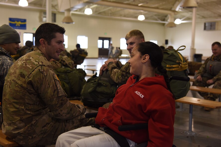 Aidan McConlin (right), a Tacoma resident who collected more than 600 candy bars for deploying service members, discusses his favorite kinds of candy with 1st Lt. Shane Winnings (left), the 2nd BN 1st SFG company executive officer, during his tour of the Troop Holding Area, McChord Field, Wash., Nov. 5, 2015. Rather than classmates keeping the candy bars during a recent school fundraiser, Aidan came up with the idea to donate all the candy bars to deploying service members. (U.S. Air Force photo/Staff Sgt. Katie Jackson)