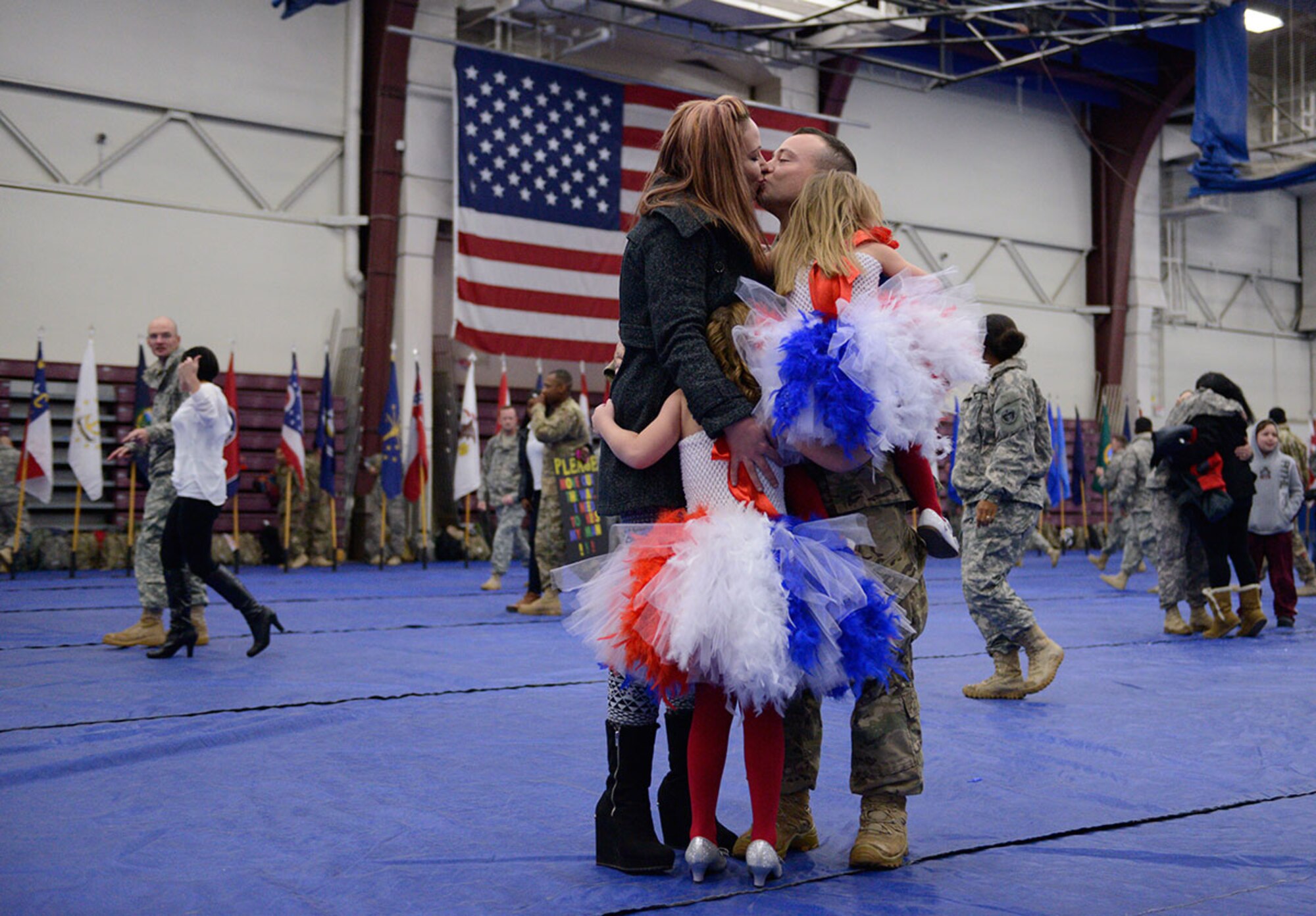 Spc. William Goodwin, assigned to the 98th Maintenance Company, 17th Combat Sustainment Support Battalion, U.S. Army Alaska, reunites with his wife Holly Goodwin, step-daughter Ashlynn Deer, 7, and daughter Maci Goodwin, 4, during a redeployment ceremony at the Buckner Physical Fitness Center Wednesday. (U.S. Air Force Photo/Airman Valerie Monroy)