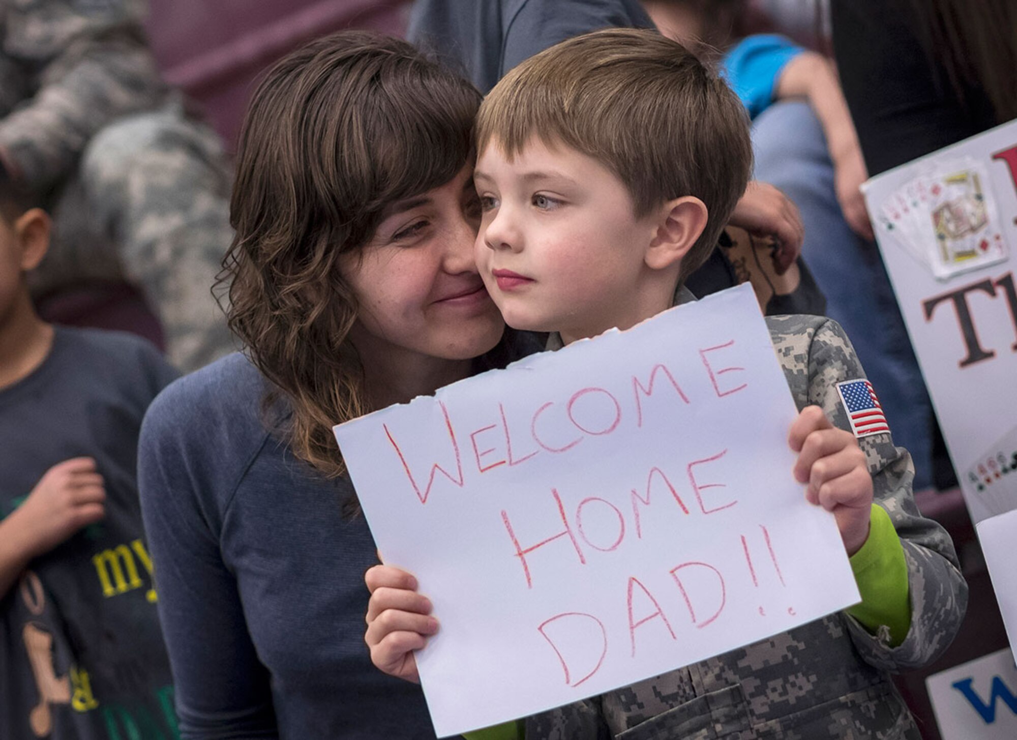Andrea Tait nuzzles her son Truman’s cheek as they wait for Army 1st Lt. Colin Tait, assigned to the 98th Maintenance Company, 17th Combat Sustainment Support Battalion, before a redeployment ceremony Wednesday. The “Wolverines” deployed to Southwest Asia for nine months in support of Operation Inherent Resolve, and Operation Enduring Freedom in Afghanistan. (U.S. Air Force photo/Justin Connaher)